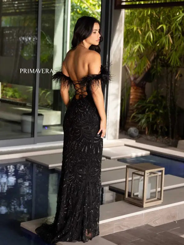 Elevate your style game with the Primavera Couture 4105 Long Prom Dress. Showcasing an off-shoulder design, this gown features a corset bodice adorned with feathers, sequins, and beads. Fitted and featuring a high slit, this formal pageant gown is perfect for making a statement at any event.