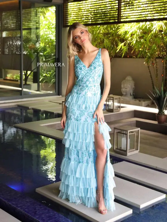 Elevate your formal look with the Primavera Couture 4106 Long Prom Dress. This stunning gown features an intricate sequin and beaded design, cascading layered ruffles, and a high slit for a touch of glamour. The fitted silhouette is perfect for showing off your figure, making this dress a statement piece for any special occasion.