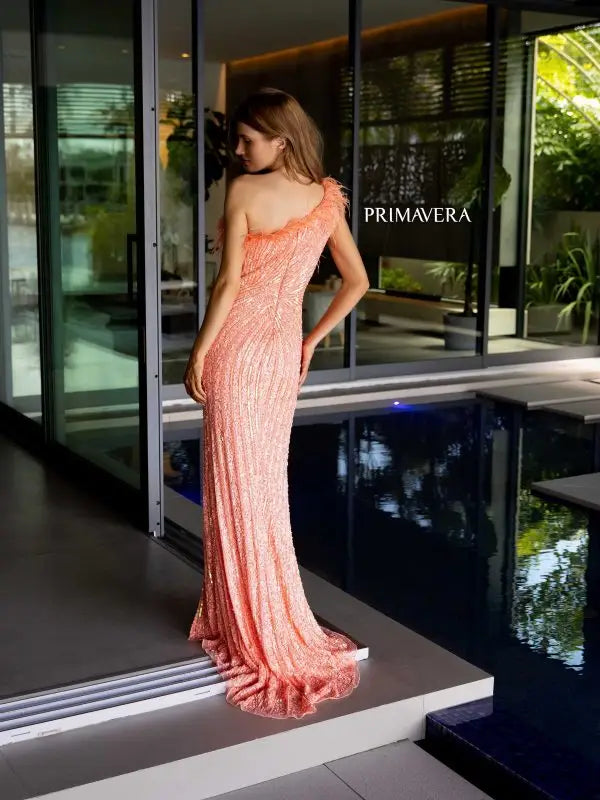 Elevate your style with the Primavera Couture 4112 long prom dress. This stunning gown features a one shoulder design with feathers, a high slit, and sequin details for a glamorous touch. Perfect for formal events, pageants, and more. Make a statement with this fitted and elegant gown.