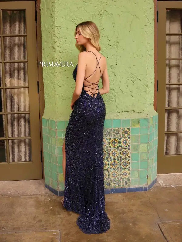 This Primavera Couture 4121 Long Prom Dress is designed with a corset and plunging neckline for a flattering and alluring fit. The high slit adds a touch of daring elegance, while the sequin embellishments provide a glamorous look. Perfect for prom, pageants, or any formal event.