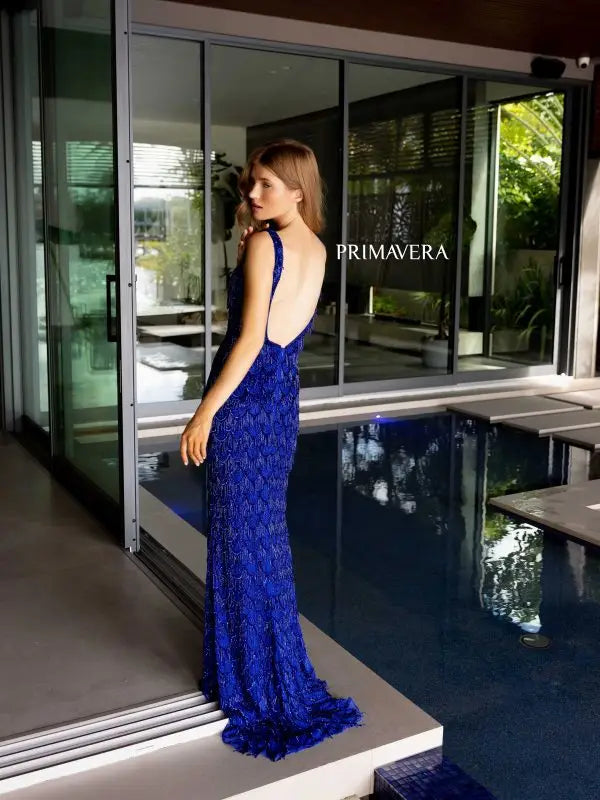 Slay the night in this stunning Primavera Couture 4129 Long Prom Dress. With fringes and sequins embellishing the tank straps and an open back, this formal pageant gown is sure to turn heads. The perfect combination of elegance and glamour for any special occasion.