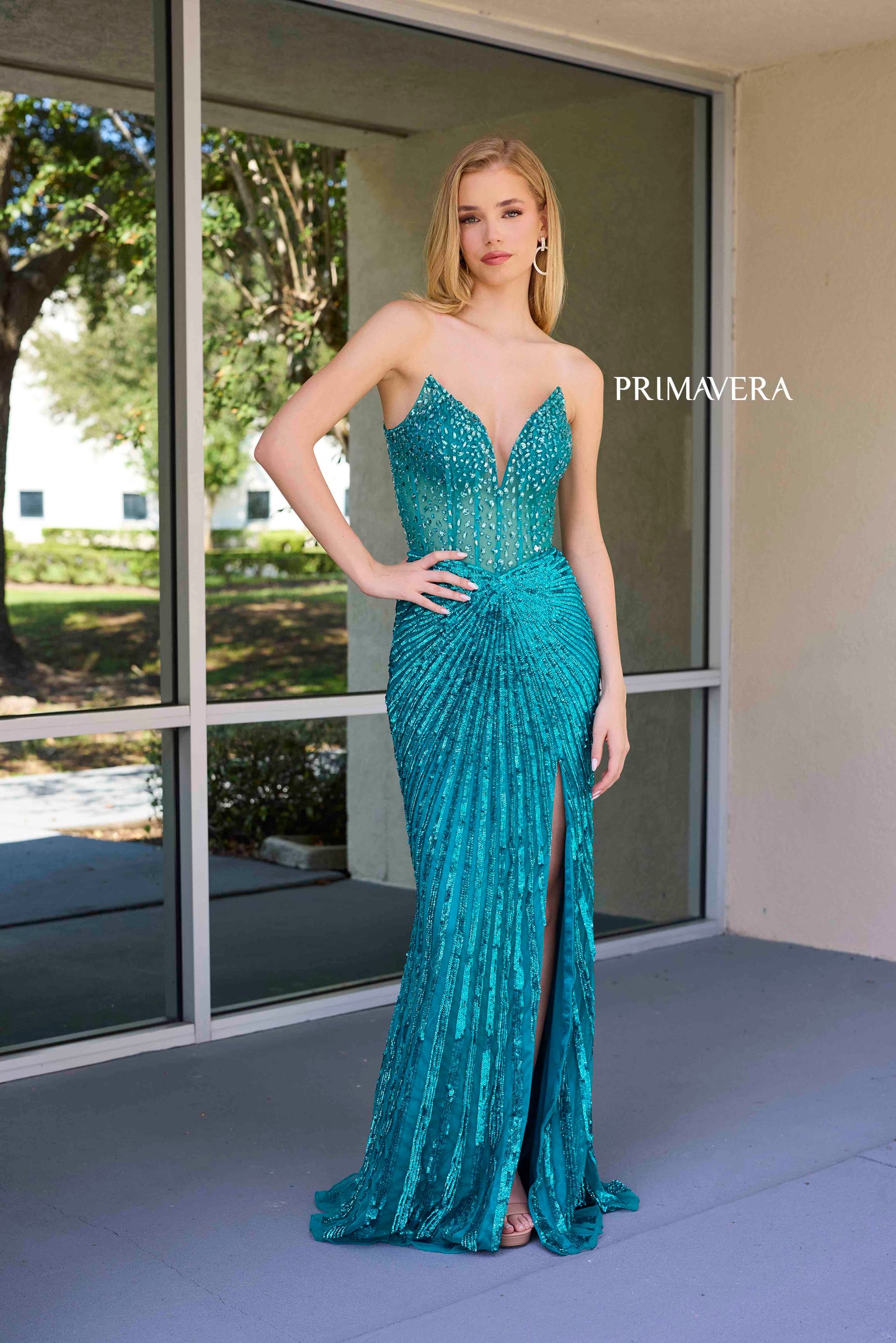 This elegant Primavera Couture 4304 Prom Dress features a sheer crystal corset, sequin detailing, and a dramatic slit in the skirt. The V-neckline adds a touch of sophistication, making it perfect for prom or pageants. Stand out from the crowd in this stunning gown.