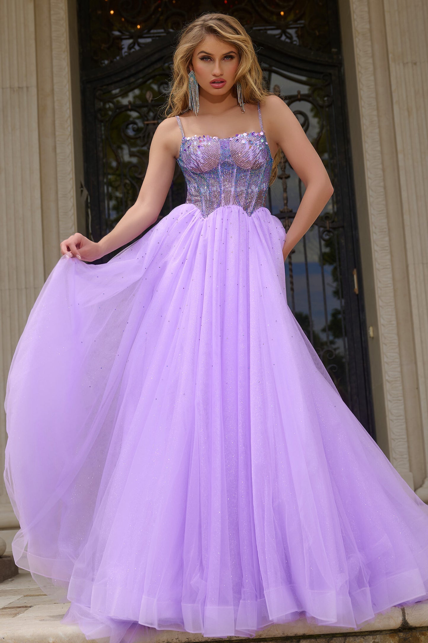 Indulge in luxury with the Jovani 44511 prom dress. Dazzling crystal bodice, A-line silhouette and shimmering sequins create a glamorous look. The scoop neck adds an elegant touch while the tulle and formal design elevate the style. Perfect for prom or pageants. Step into elegance with this exquisite ball gown, featuring a fitted beaded corset bodice that shimmers with intricate details. 