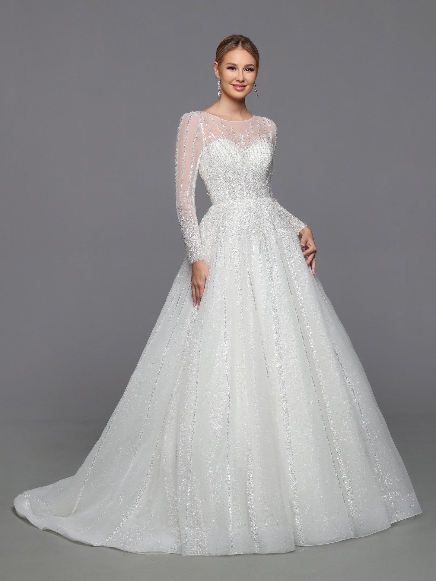 DaVinci Bridal 50764 A-Line Ballgown High Neck Long Sleeve Open Back Train Wedding Gown. On-trend glitter tulle brings this ball gown to life. Designer details include a sheer bodice, full-length sleeves, and a corset back.