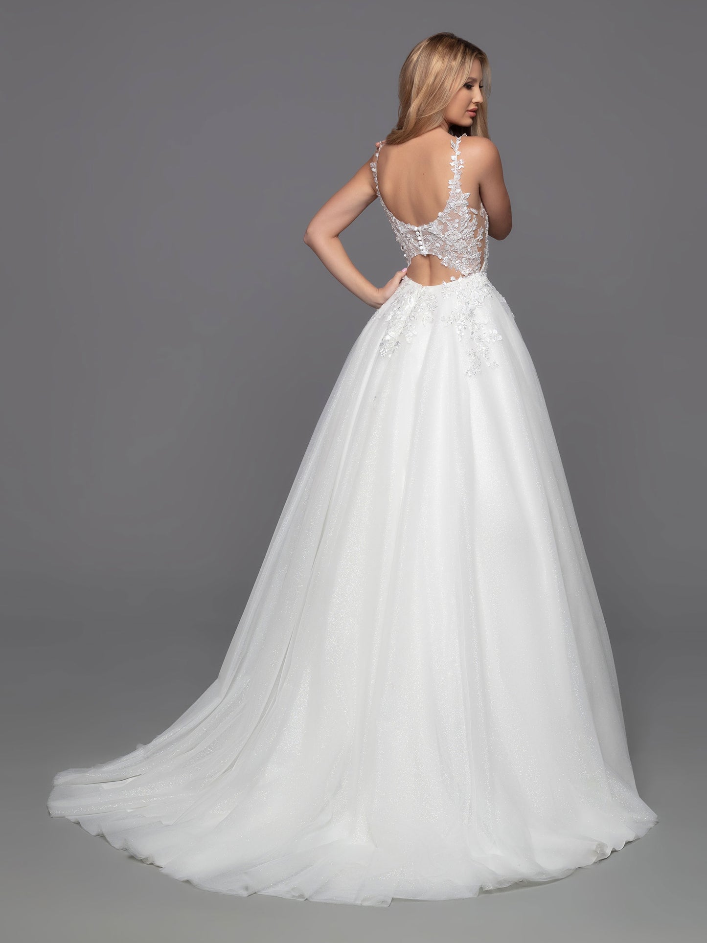 Davinci Bridal 50801 Long Shimmer Tulle Ballgown Sheer lace wedding dress Open Back is a timeless choice with a modern twist. This ball gown features a classic layered tulle skirt and a contemporary bodice with sheer sides, a low keyhole and covered button detail. The perfect combination of style and sophistication for any special occasion.  Sizes: 2-20  Colors: Ivory