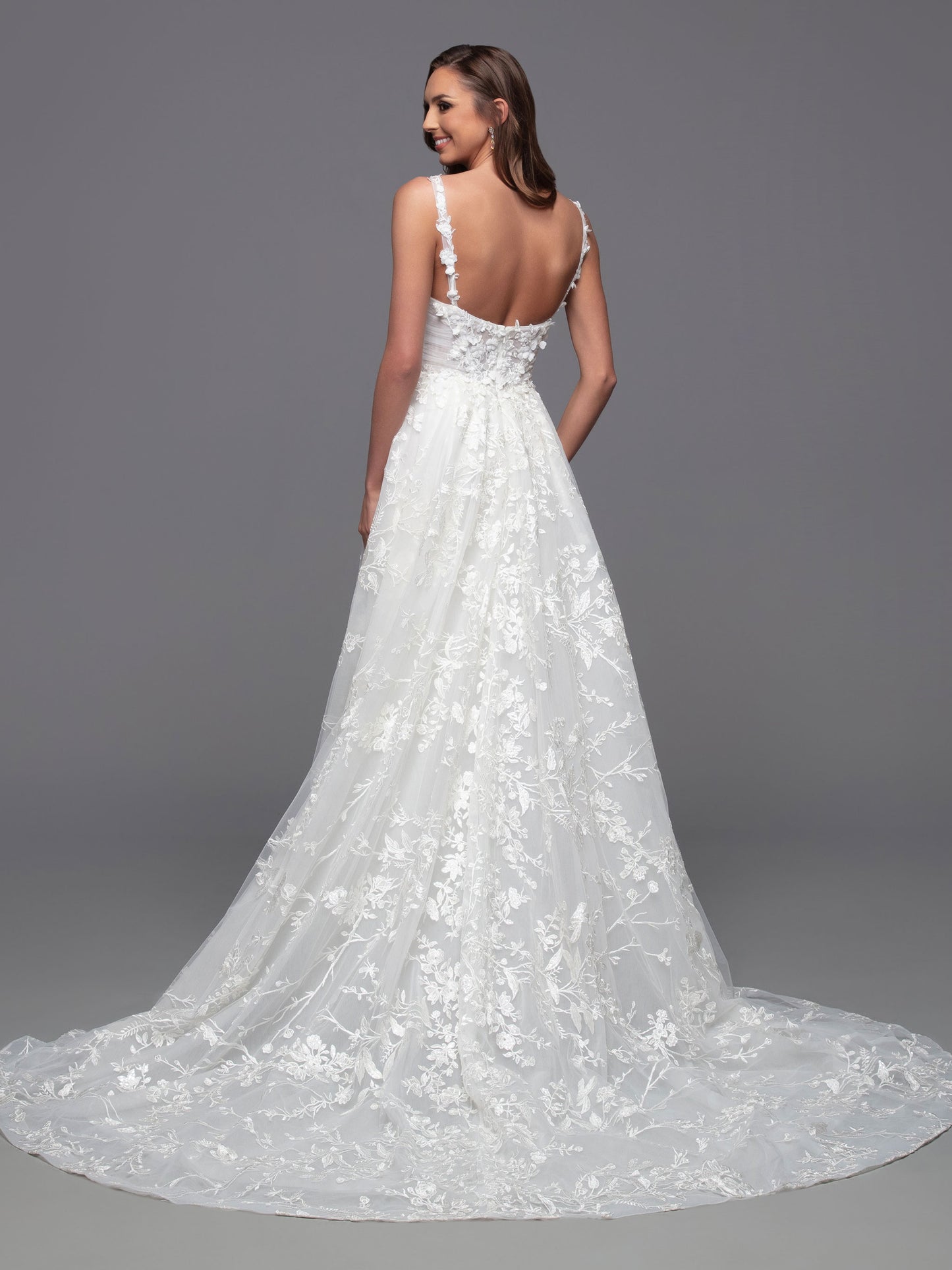 Look stunning on your special day in this Davinci Bridal 50806 A Line Lace Cape Wedding Dress. Constructed with a sheer crystal plunging neckline and 3D floral embroidery on the front and back bodice, this gown provides an exquisite look with gathered skirt and chapel train. Plus, you can customize your look and stand out in photos with the addition of the detachable veil wings.  Sizes: 2-20  Colors: Ivory