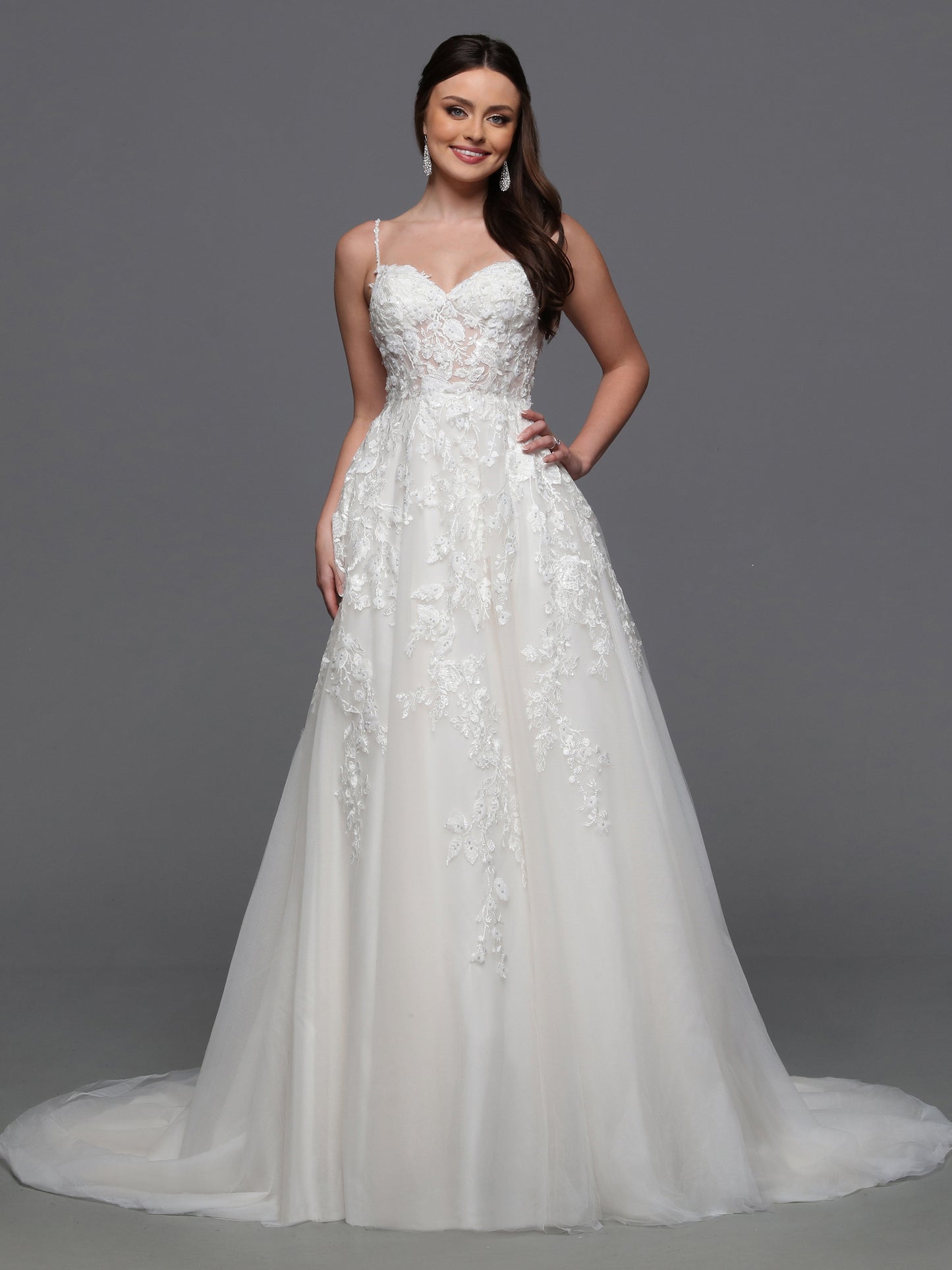 Indulge in luxury and grace with the Davinci Bridal 50834 3D Lace A Line Wedding Dress. Adorned with a detachable cape sleeves and sheer beading, this gown exudes elegance and sophistication. The 3D lace detail adds a touch of artistry, making you feel like a walking masterpiece on your special day. One of our most unique detachable styles, this wedding dress has lace gauntlets with veil wings that add drama to your portraits and your walk down the aisle.