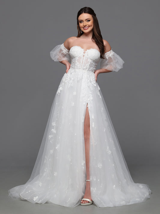 Make a statement on your special day with the Davinci Bridal 50836 A line Puff Sleeve Wedding Dress. The sheer corset enhances your silhouette while the beaded accents add a touch of glamour. With a slit for effortless movement and luxurious puddle sleeves, this dress exudes elegance and sophistication. Flirty and fashionable, this ball gown wedding dress has a sheer lace bodice, peek-a-boo slit skirt and delicate detachable sleeves.