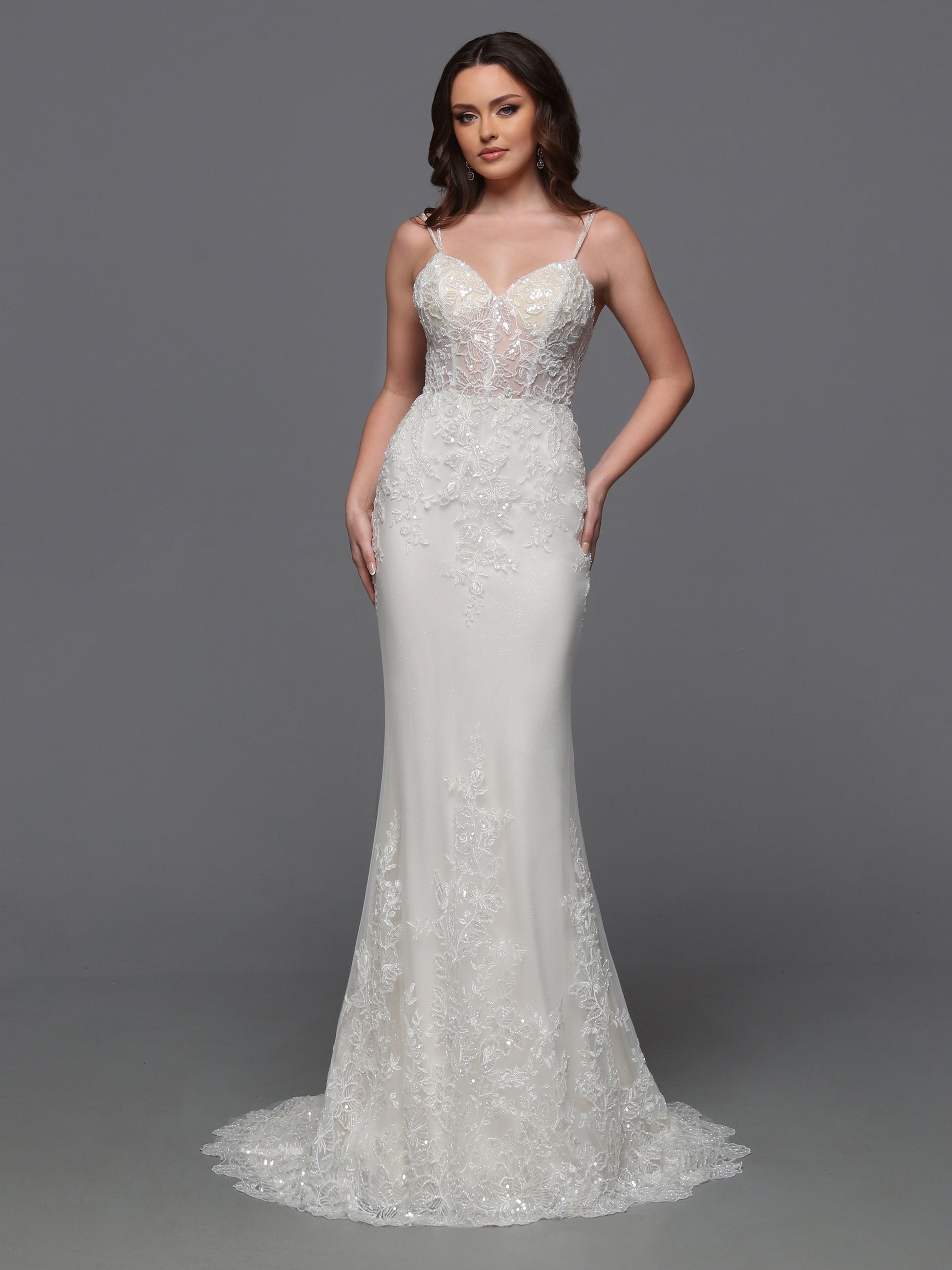 Elevate your bridal look with the Davinci Bridal 50843 wedding dress. This luxurious gown features a sheer embroidered bodice with intricate beading, adding a touch of glamour to your special day. The detachable overskirt adds a layer of versatility, making this gown perfect for any venue. Sparkle and shine with the sequin details, making you the star of the show. The detachable tulle skirt turns this pretty lace slip dress design into a full-fledged ball gown wedding dress.