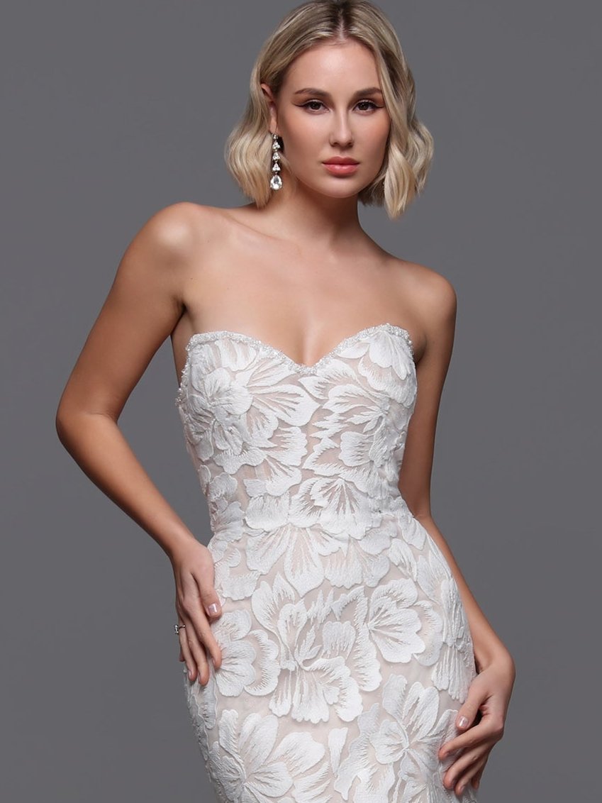 Indulge in elegance with the Davinci 50870 Embroidered Lace Wedding Dress. This strapless mermaid gown is adorned with delicate lace and shimmering beadwork along the bust and detachable spaghetti straps, exuding luxury and sophistication. The perfect choice for a glamorous and timeless bridal look. Experience true beauty on your special day.