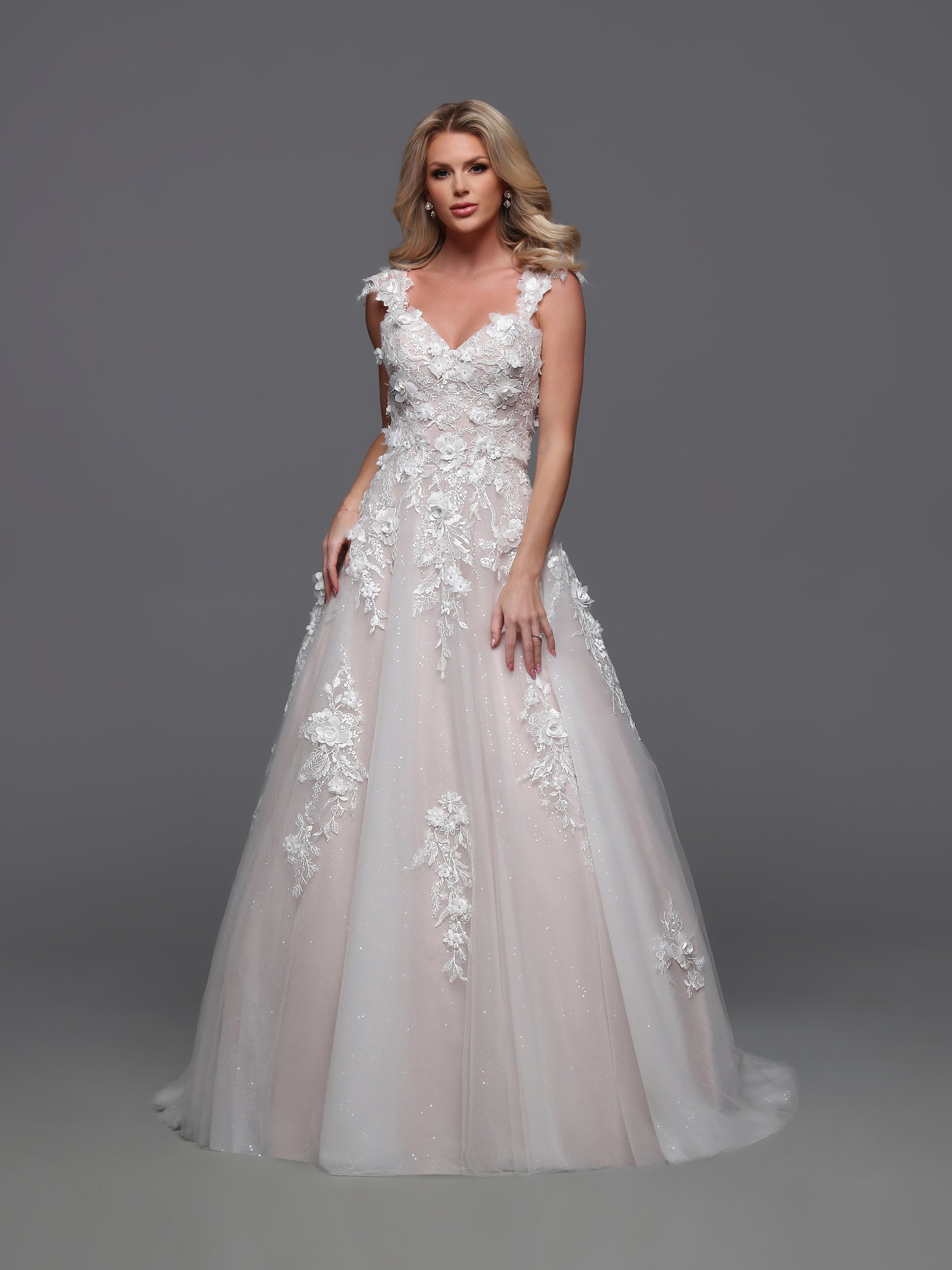 Elevate your elegance with the Davinci 50883 wedding dress. Beautifully designed with a detachable off shoulder sleeve and corset bodice, this A line lace gown exudes luxury. The sequin shimmer ballgown adds a touch of glamour, creating a one-of-a-kind bridal look that will leave a lasting impression.