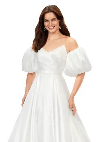 Ashley Lauren 11323 Strapless Detachable Puff Sleeves Phantom Satin Ballgown Dress. This stunning sweetheart ball gown comes with detachable balloon sleeves that give the perfect flare. The back of the gown is adorned with buttons.