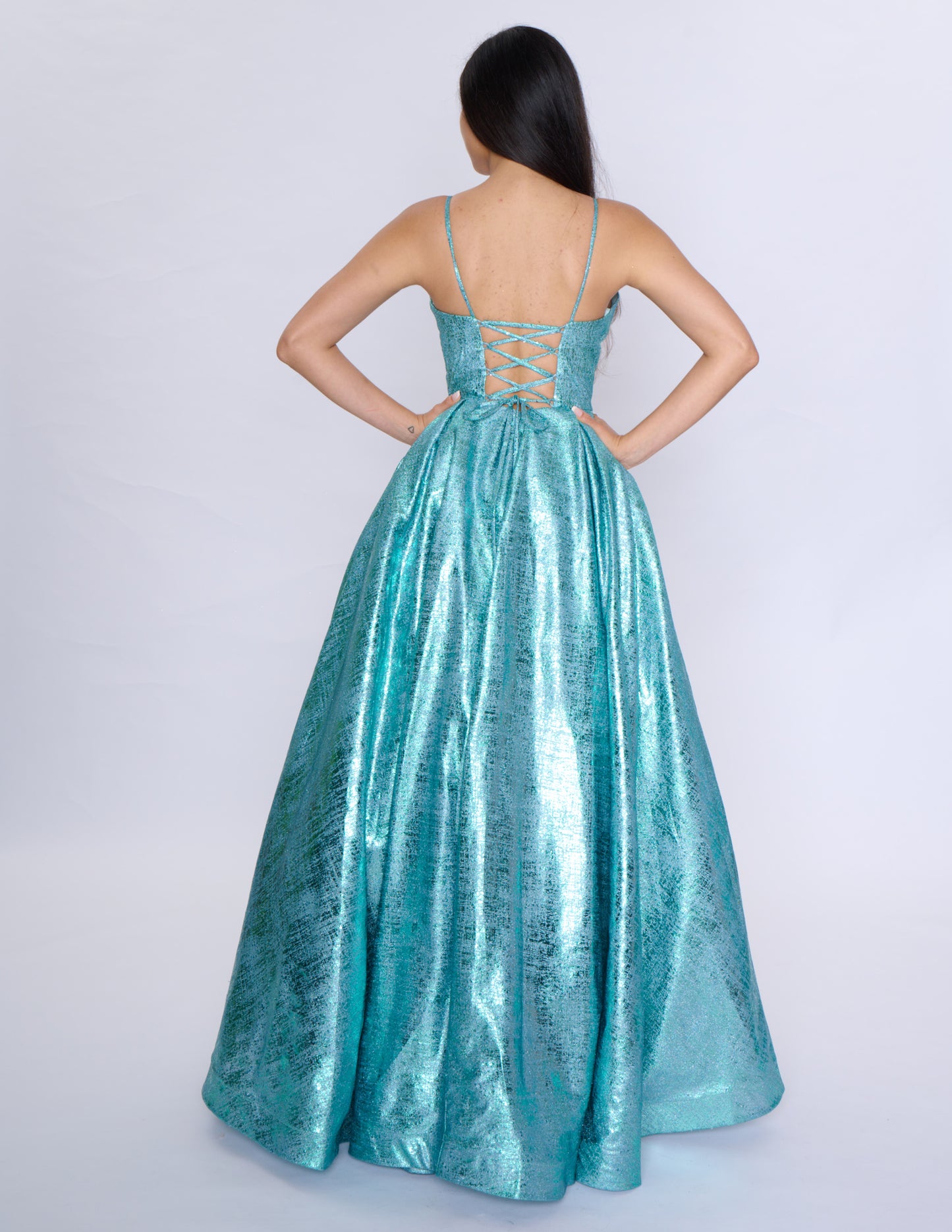 Elevate your formal attire with the Nina Canacci Metallic Ballgown. Stunningly designed with a corset-style bodice and V-neckline, this A-line gown exudes elegance and grace. Made with a metallic fabric, it adds a touch of shimmer to your look. Perfect for prom or any formal event, this dress will make you feel like royalty.

Sizes: 2-18

Colors: Black, Aqua, Rose