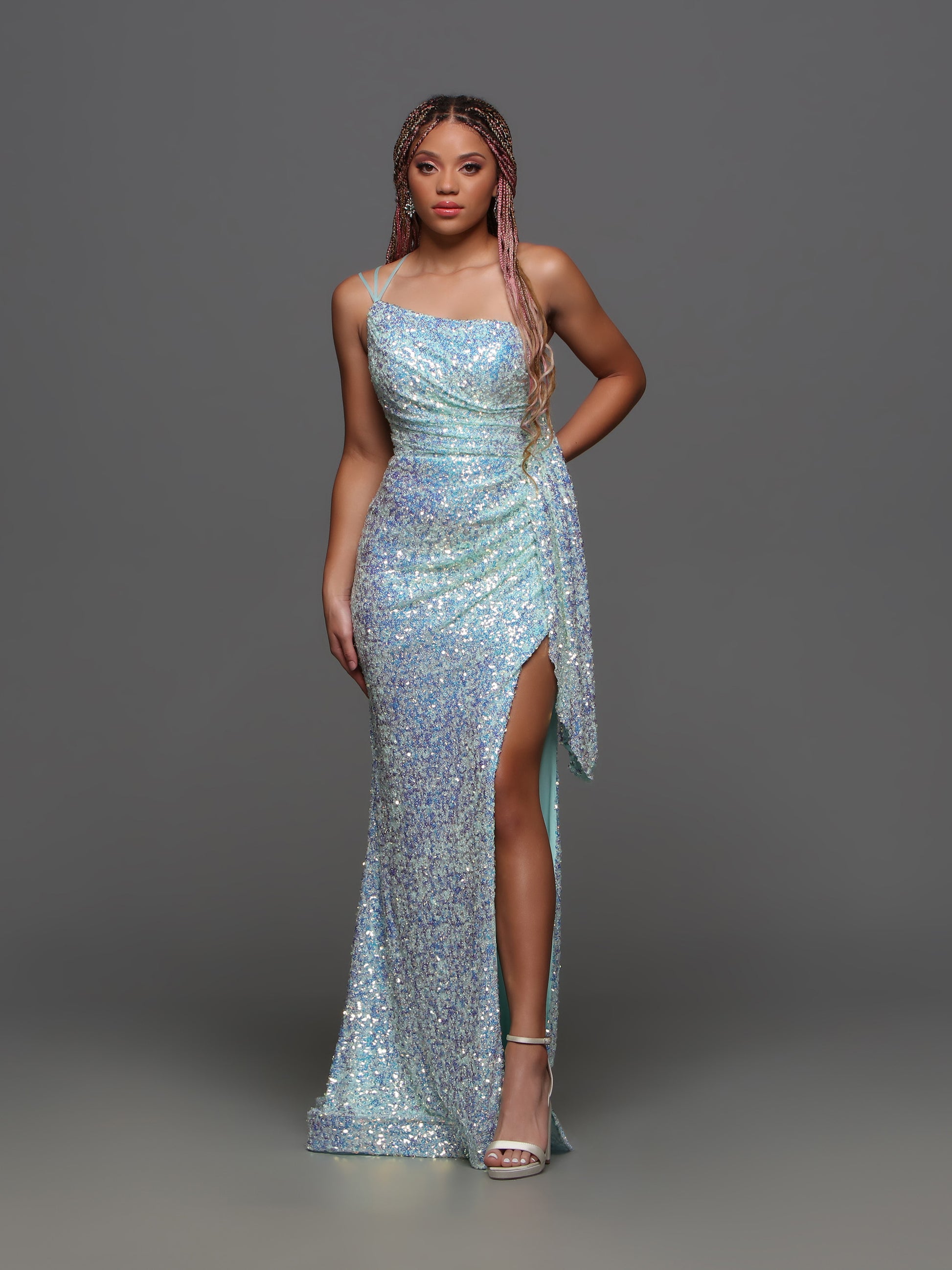 The Candice Wang 72346 prom dress boasts stunning sequins, a one shoulder design, and a high slit for an elegant and alluring look. With a draped open back, this formal gown exudes sophistication and glamour. Step out in style and turn heads at your next special occasion.  Sizes: 4-12  Colors: Aqua