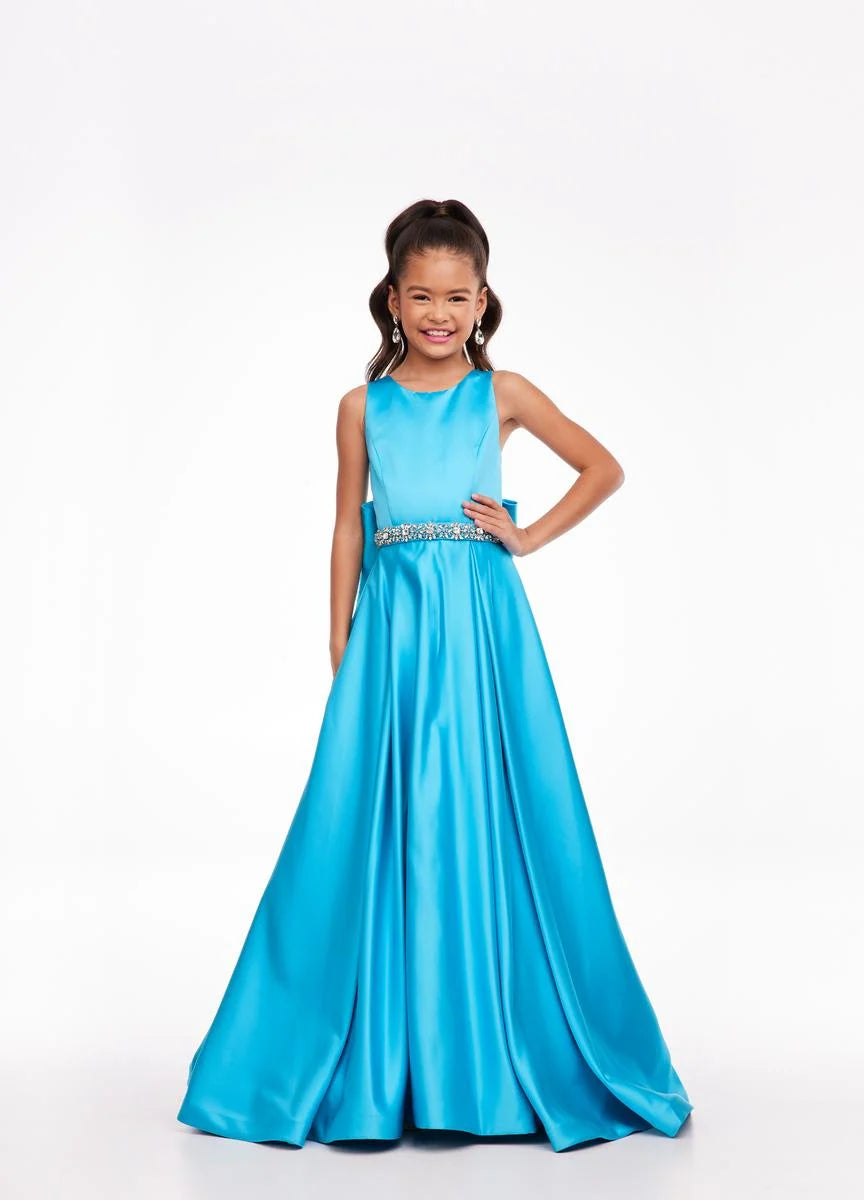 This Ashley Lauren 8079 Size 12 Ivory Long satin A Line girls Pageant Dress features an elegant crew neckline, a crystal encrusted waistline, and an A-line skirt that is complemented by a detachable bow at the back. Perfect for formal occasions, this high-quality gown will make your little girl look beautiful.  Size: 12  Color: Ivory