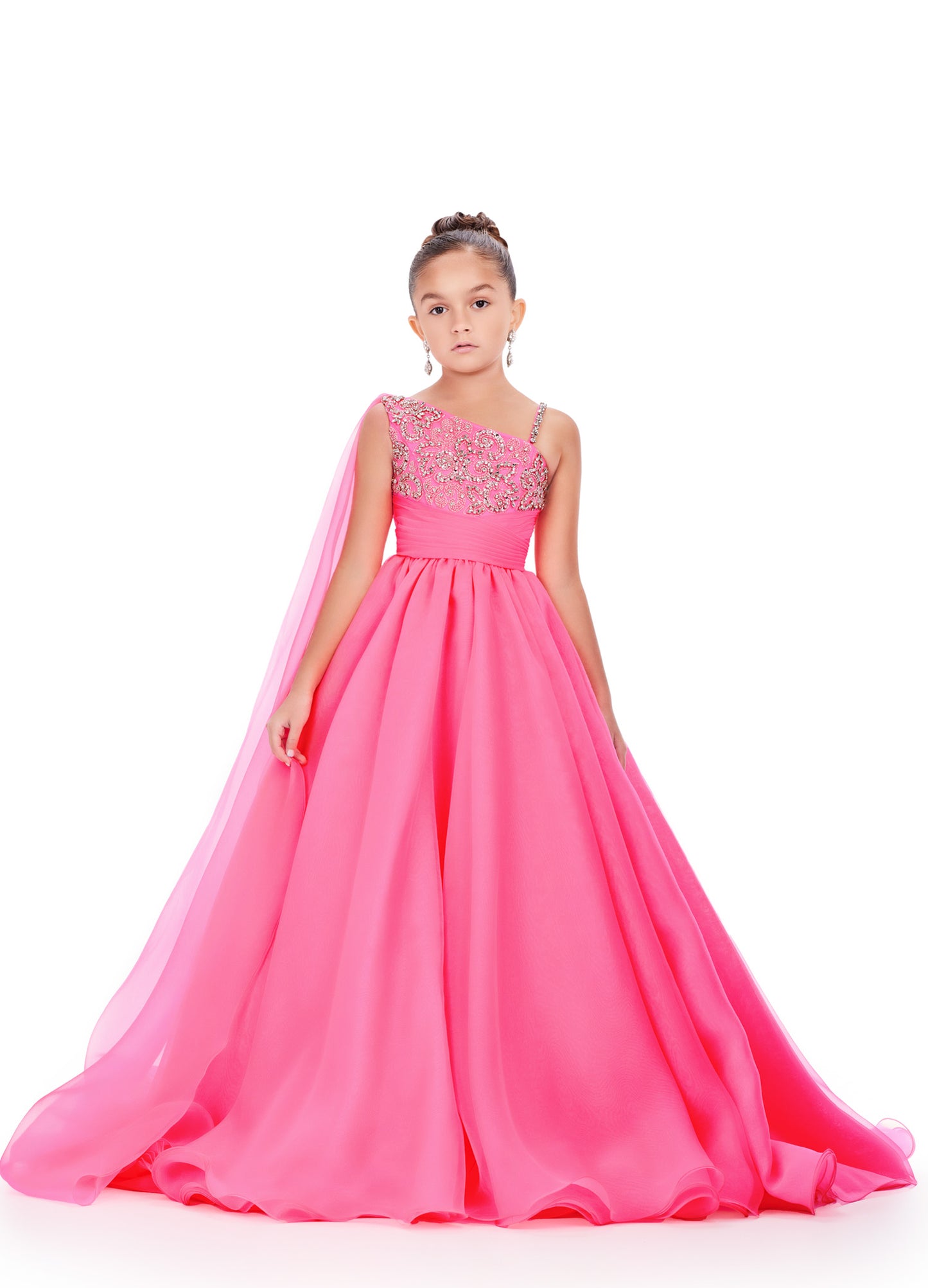 This Ashley Lauren Kids 8212 one-shoulder girls' pageant dress is both elegant and fun. With a cape design and crystal embellishments, this A-line ball gown is perfect for any pageant or special occasion. Look and feel like a princess in this stunning dress. This gorgeous organza ball gown is meant for a future queen! Featuring a stunning beaded bustier and one shoulder cape, this gown is sure to stun!