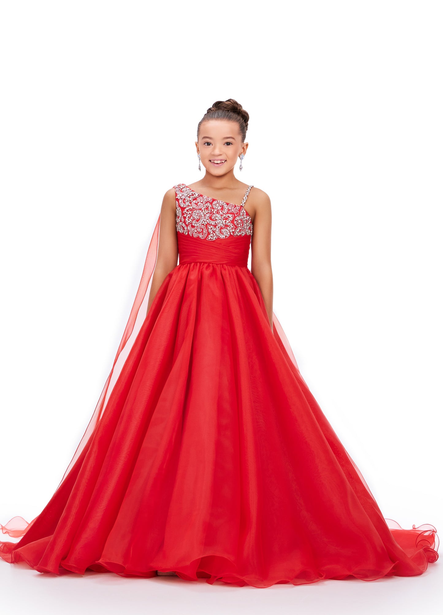 This Ashley Lauren Kids 8212 one-shoulder girls' pageant dress is both elegant and fun. With a cape design and crystal embellishments, this A-line ball gown is perfect for any pageant or special occasion. Look and feel like a princess in this stunning dress. This gorgeous organza ball gown is meant for a future queen! Featuring a stunning beaded bustier and one shoulder cape, this gown is sure to stun!