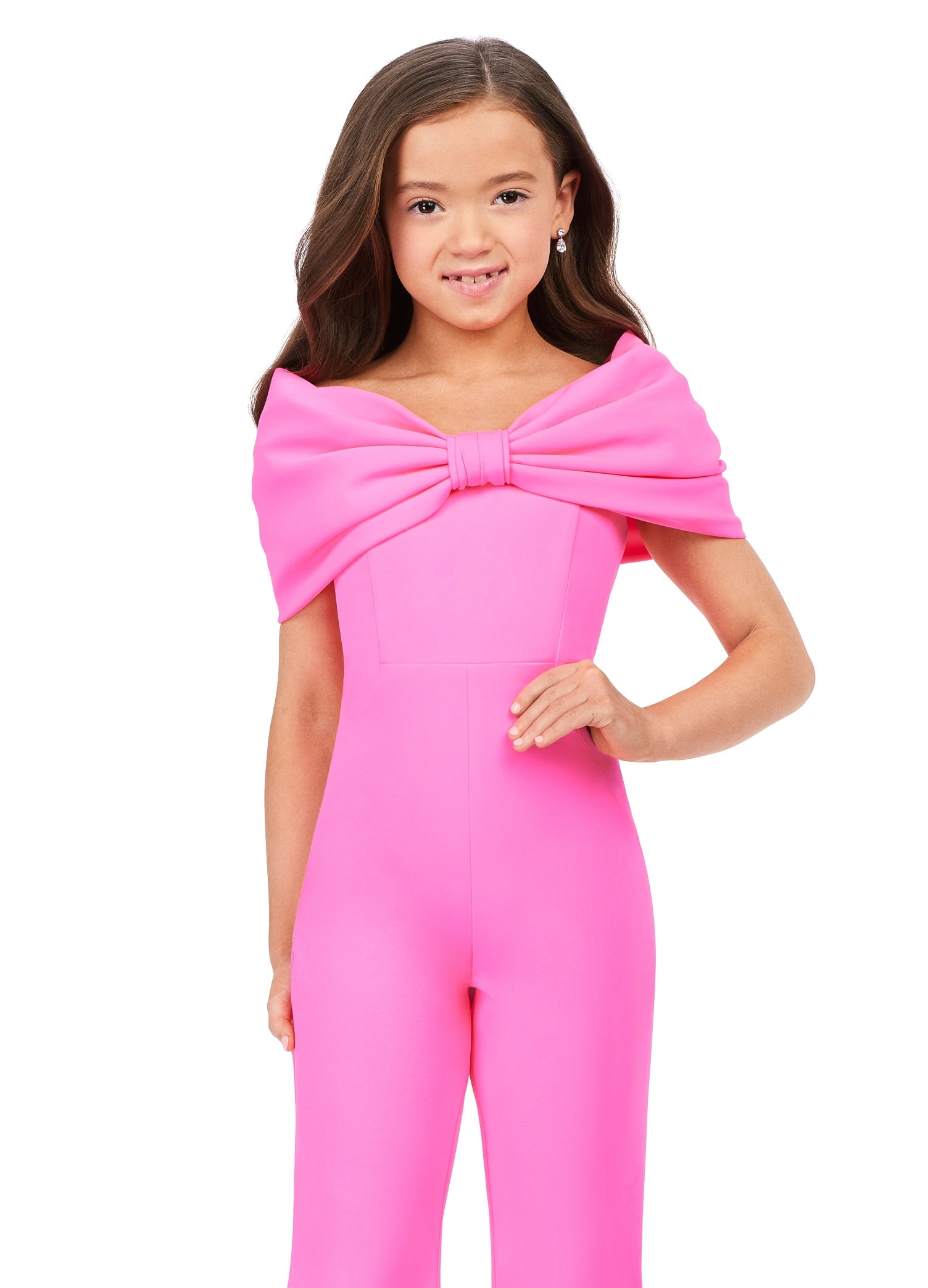 She'll be the talk of the town in the Ashley Lauren Kids 8227 Jumpsuit. Crafted from scuba material, this fashionable design features an off-shoulder bodice with an oversized bow and flare pant legs for a modern touch. Perfect for any special occasion.  Sizes: 4-16  Colors: Red, Hot Pink, Turquoise, White/Black