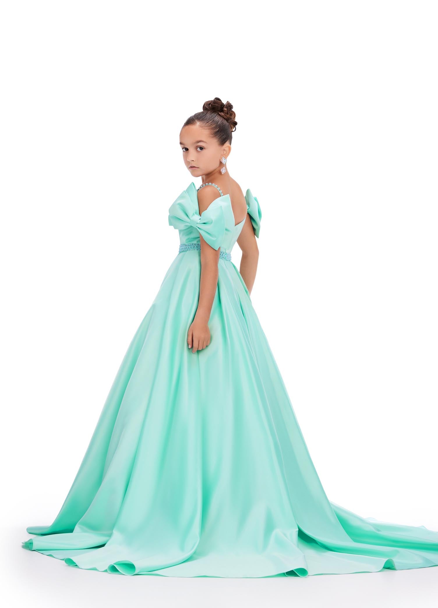 Ashley Lauren Kids 8237 Off the Shoulder Satin Ball Gown Pageant Dress Bows A Line Girls Feel like a princess in this satin ball gown. This gown features off the shoulder bows and pearl accents on the straps and belt.  COLORS: Aqua, Pink, White, Lilac Sizes: 2-16 Off Shoulder Beaded Accents Ball Gown Satin