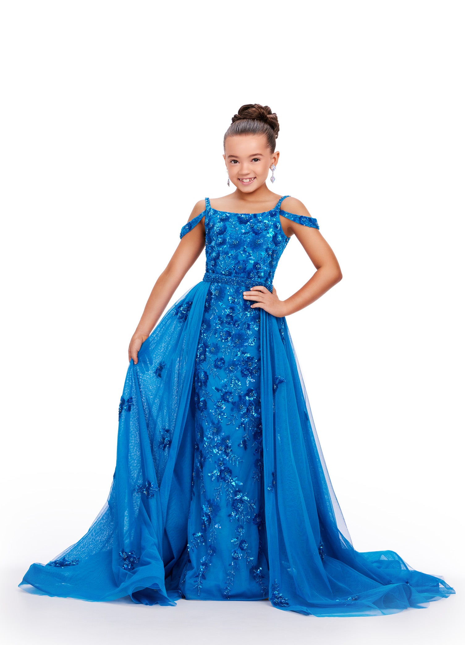 Expertly crafted for little girls who deserve to sparkle, the Ashley Lauren 8239 dress will make her shine on stage. The fitted silhouette flatters any figure while the beaded details and sequin overlay add a touch of glamour. Perfect for pageants and formal events. Bring the drama in this beaded column gown with shoulder draping straps. The removeable tulle overskirt is embellished with scattered beaded accents.