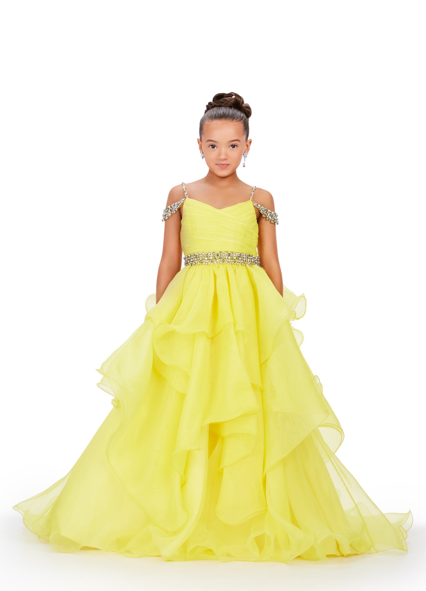 Glam up your little one's pageant look with the Ashley Lauren Kids 8250 A Line Ruffle Dress. This stunning ballgown features a delicate off-the-shoulder neckline, adorned with intricate beading. The ruffled A-line skirt adds a touch of elegance, making your child shine on stage. Perfect for any formal occasion. 