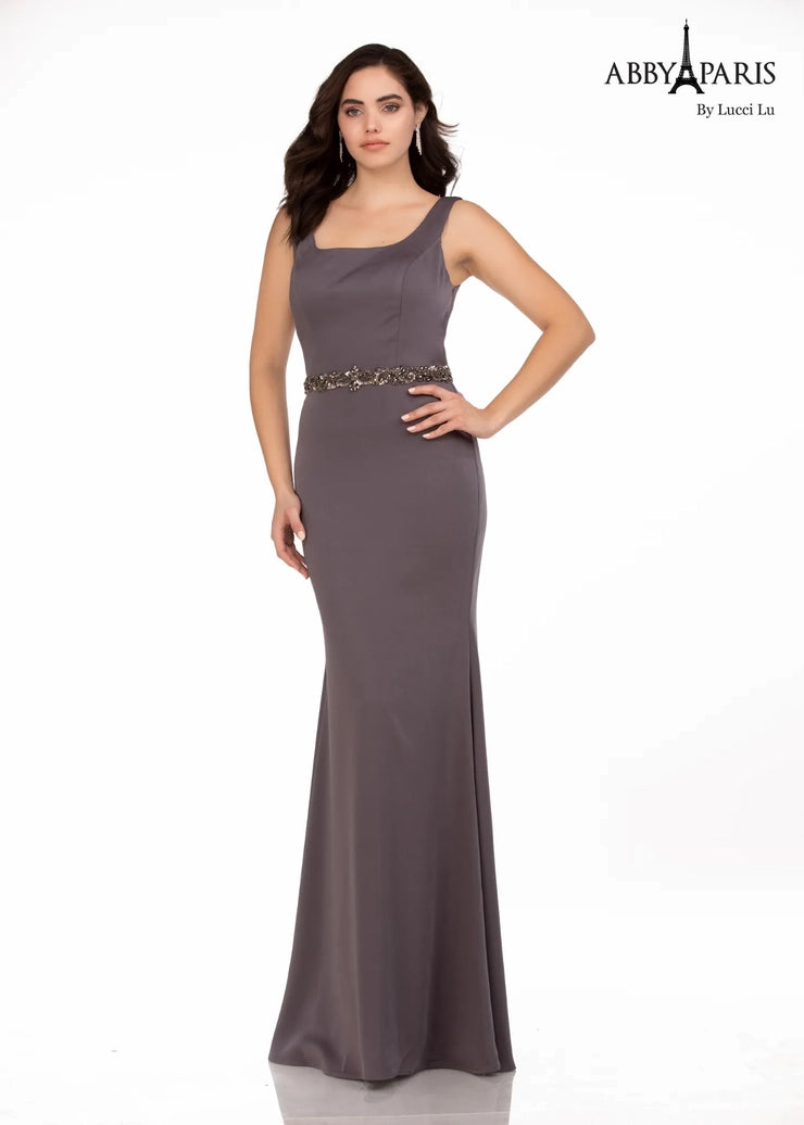 Abby Paris 96062W A-Line Detachable Short Drape Cape Embellished Belt Plus Size MOB Formal Gown. This Abby Paris 96062W A-Line Formal Gown is a stunning and sophisticated choice for the modern woman. Its A-line silhouette flatters and highlights your curves, while the detachable short drape cape adds a chic and unique twist to a timeless style. The embellished belt adds a bit of sparkle to complete the look.