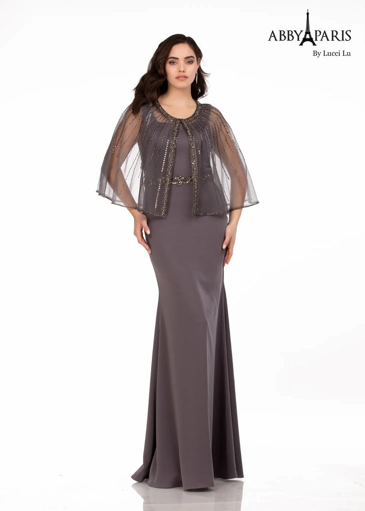 Abby Paris 96062W A-Line Detachable Short Drape Cape Embellished Belt Plus Size MOB Formal Gown. This Abby Paris 96062W A-Line Formal Gown is a stunning and sophisticated choice for the modern woman. Its A-line silhouette flatters and highlights your curves, while the detachable short drape cape adds a chic and unique twist to a timeless style. The embellished belt adds a bit of sparkle to complete the look.