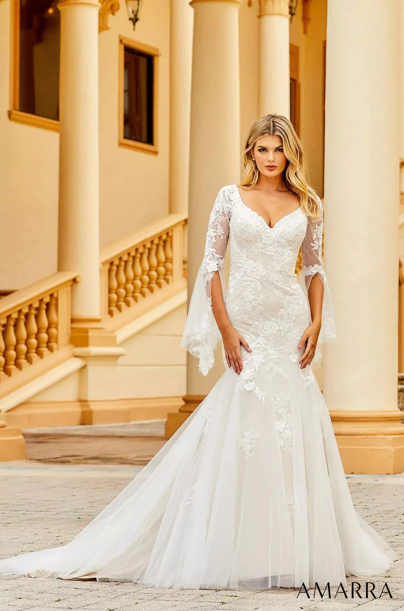 Amarra Bridal 84386 "Anna" Mermaid V-Neck Sheer Floral Long Sleeve Train Wedding Dress. If you’re looking for a wedding gown that shows some skin, but not too much, meet Anna. This captivating gown features a deep-v neckline and sheer sleeves that cover the arms, but still dare to show a little skin