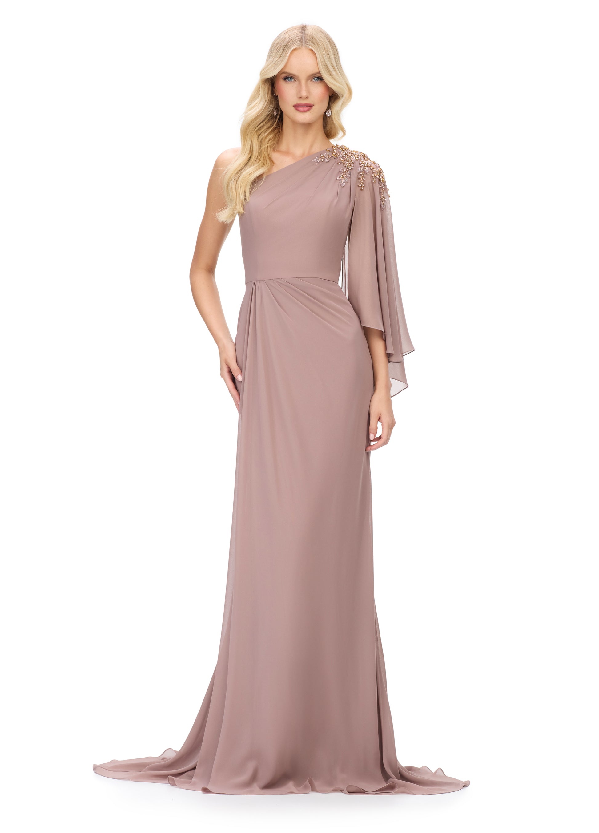 The Ashley Lauren 11701 evening gown boasts a one shoulder design with a single flowy chiffon sleeve, a ruched waist, and an embellished shoulder. This elegant and sophisticated dress is perfect for any special occasion, providing a flattering silhouette and eye-catching details. Elevate your evening look with this stunning piece.