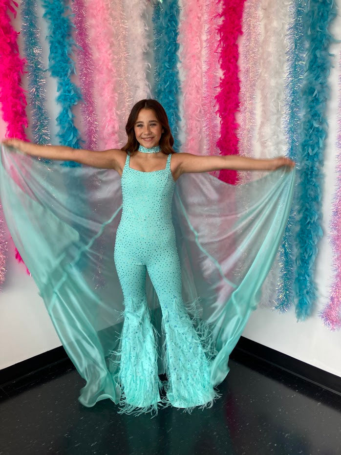 Ashley Lauren Kids 8210 Long Girls Pageant Jumpsuit with Crystal embellishements and a scoop neckline. Feather Embellished flared Bell Bottoms with a choker embellished with crystals and organza Cape.  Sizes: 4-16  Colors: Aqua, Fuchsia