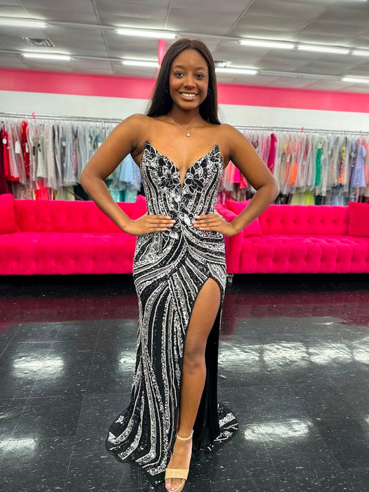 Ashley Lauren 11236 Long Fitted V Neck Slit Beaded Sequin Prom Dress Pageant Gown This strapless gown is sure to turn heads. The sweetheart neckline is complete with a modern floral sequin motif that continues down the bustier and skirt. The skirt is complete with a left leg slit.

COLORS: Black/Silver