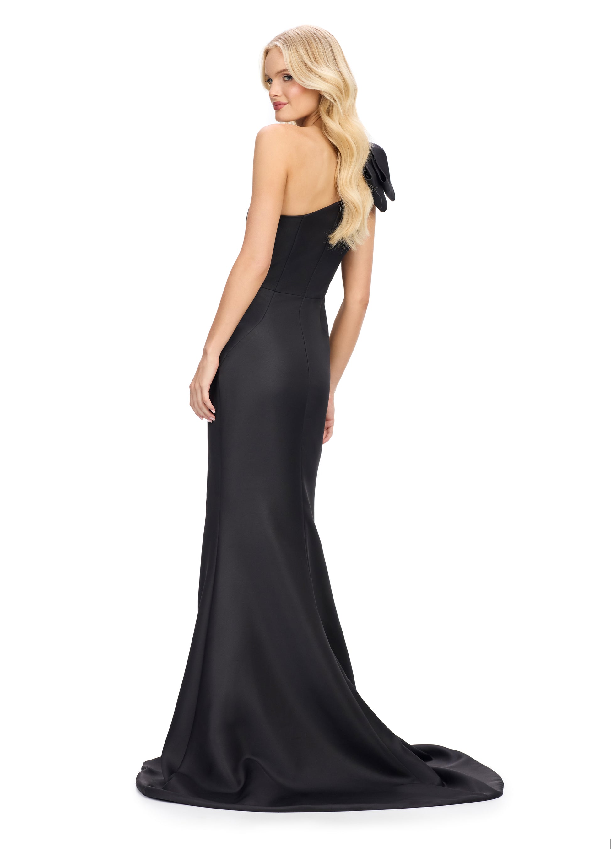 This Ashley Lauren satin evening gown combines elegance with modern details. The one shoulder design and bow add a touch of sophistication, while the ruched waist and short slit provide a flattering fit and added comfort. Perfect for any special occasion, this gown is sure to make you look and feel stunning.