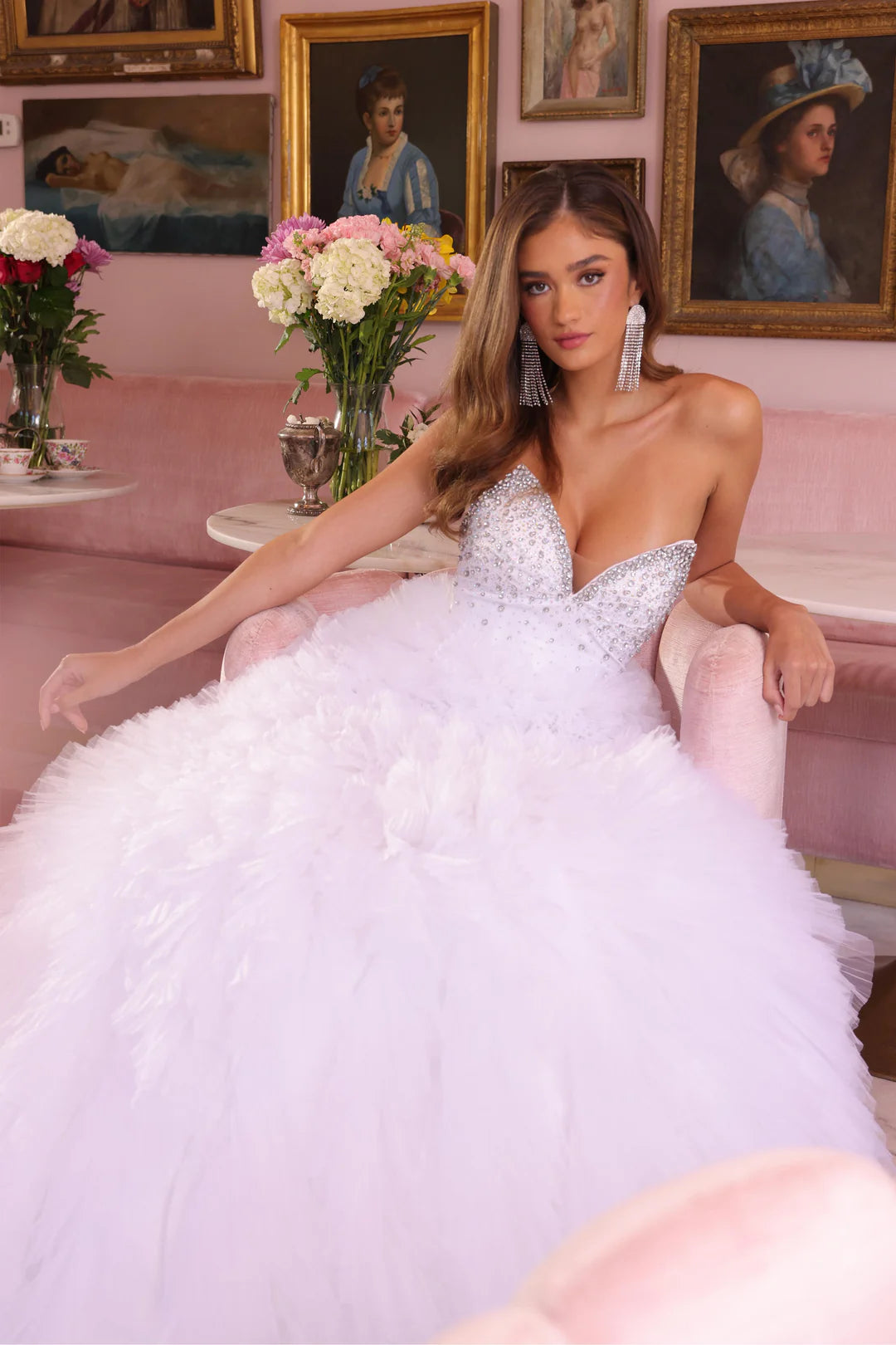 This Ava Presley gown, style 29528, embodies a fairytale elegance with its voluminous, layered tulle skirt and sparkling bodice. The plunging neckline adds a hint of allure while the glittering embellishments across the bodice bring a dazzling touch to the design. The dramatic skirt creates a princess-like silhouette, making it ideal for a formal occasion or even a modern wedding. Amazing Prom &amp; Pageant Dress!