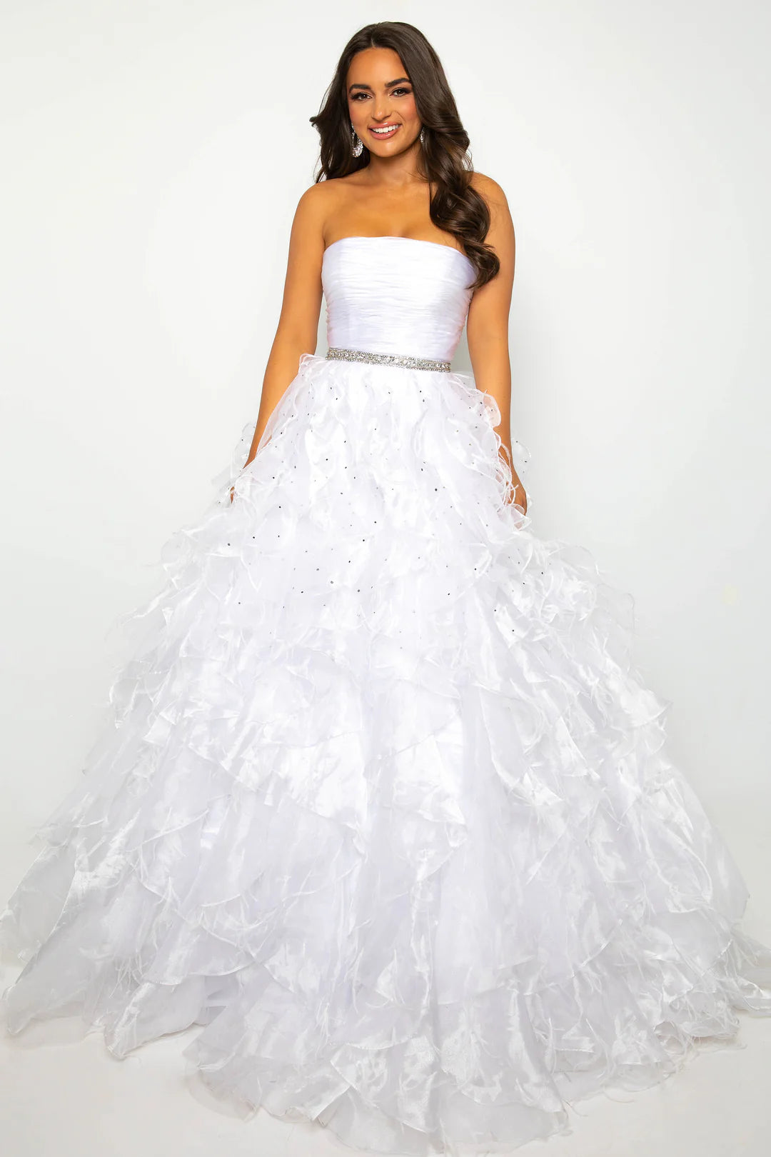 Elevate your formal attire with the Ava Presley 39555 Ballgown. This luxurious dress boasts a long feather ruffle and a strapless design, exuding elegance and style. Perfect for prom or pageants, this exclusive dress will make you feel like a true fashion icon. Float down the runway in this ethereal strapless ball gown, featuring a ruched bodice and cascading ruffle skirt that brings volume and drama. The cinched waist, adorned with a sparkling belt, adds a touch of glamour to this stunning look. Perfect fo