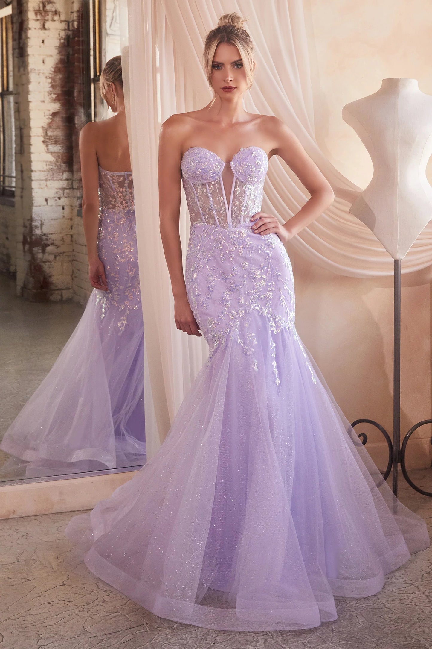 The Ladivine CB139 prom dress boasts a sheer corset bodice that adds a hint of allure to this shimmering dress. The mermaid silhouette and strapless design give a stunning, formal look that will turn heads. Perfect for prom or any special occasion. Look absolutely breathtaking in this beautiful strapless mermaid gown.