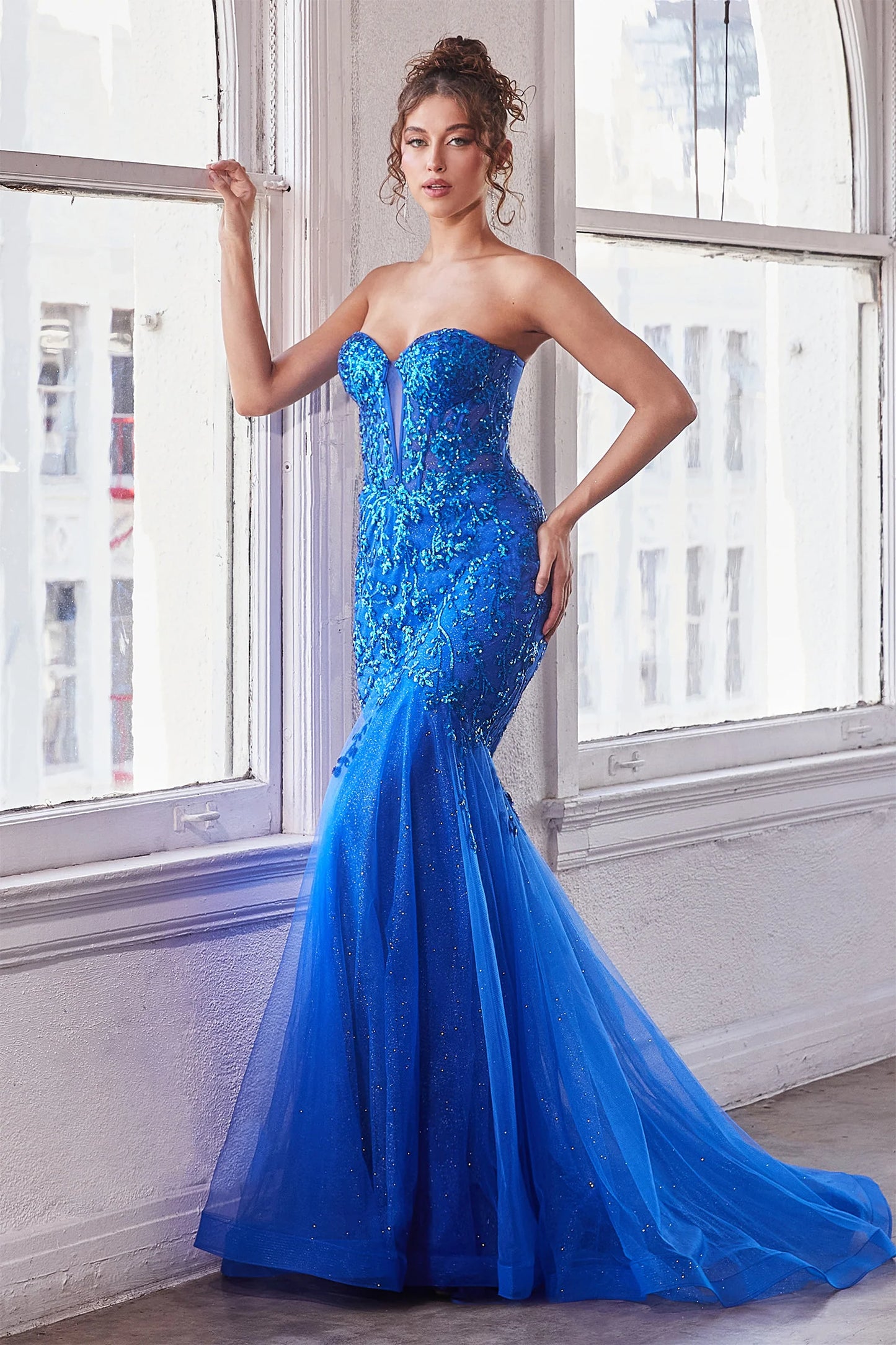 The Ladivine CB139 prom dress boasts a sheer corset bodice that adds a hint of allure to this shimmering dress. The mermaid silhouette and strapless design give a stunning, formal look that will turn heads. Perfect for prom or any special occasion. Look absolutely breathtaking in this beautiful strapless mermaid gown.