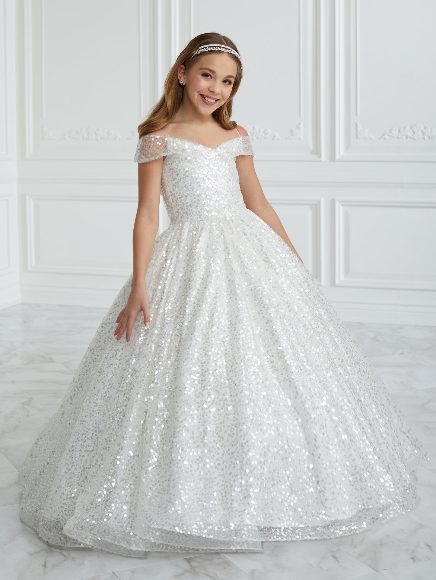 This stunning Tiffany Princess 13679 pageant dress features a dazzling sequin design, off the shoulder neckline, and a full ball gown silhouette, making your little one feel like royalty. Perfect for formal events and pageants, this dress is both elegant and eye-catching