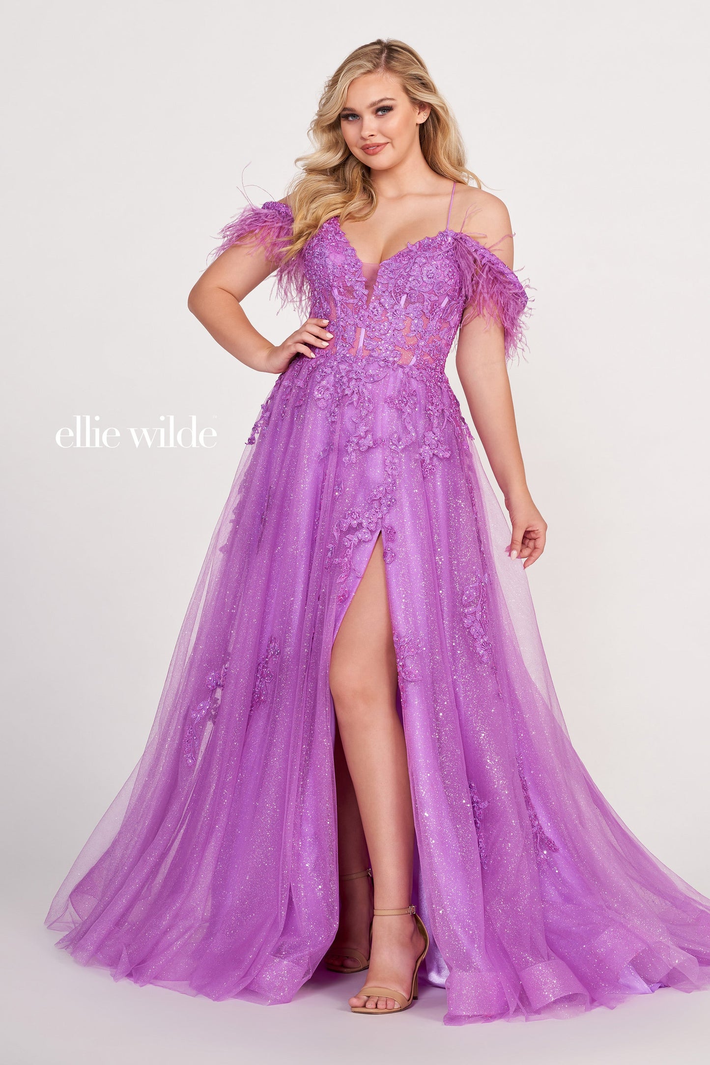 The Ellie Wilde EW34066 is a stunning A-line gown with a sheer sequin corset and feather off-the-shoulder detail. Boasting a dazzling shimmer finish and dramatic slit, this exquisite dress will make you the belle of the ball.  Sizes: 00-16  Colors: ORANGE, RED, PERIWINKLE, IRIS