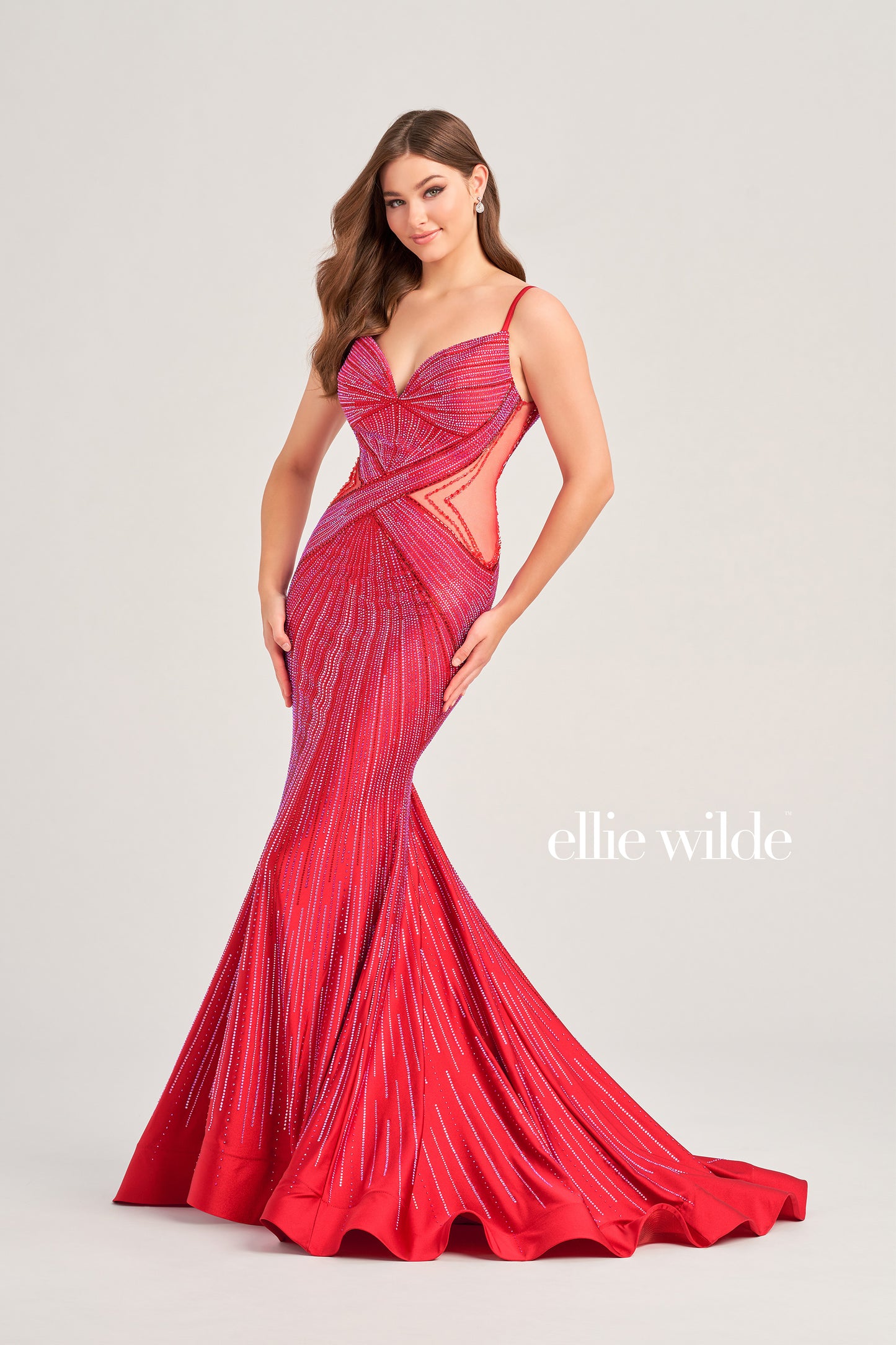 This Ellie Wilde formal dress is perfect for any prom or special event. The fitted crystal jersey construction features sheer mesh cutouts on the sides and a backless mermaid design for a perfect fit. It's finished with a low v-neck for a timeless look.  COLOR: BLACK, LIGHT BLUE, NAVY BLUE, ROYAL BLUE, HOT PINK, RUBY, IRIS, LAVENDER FROST SIZE: 00 - 20