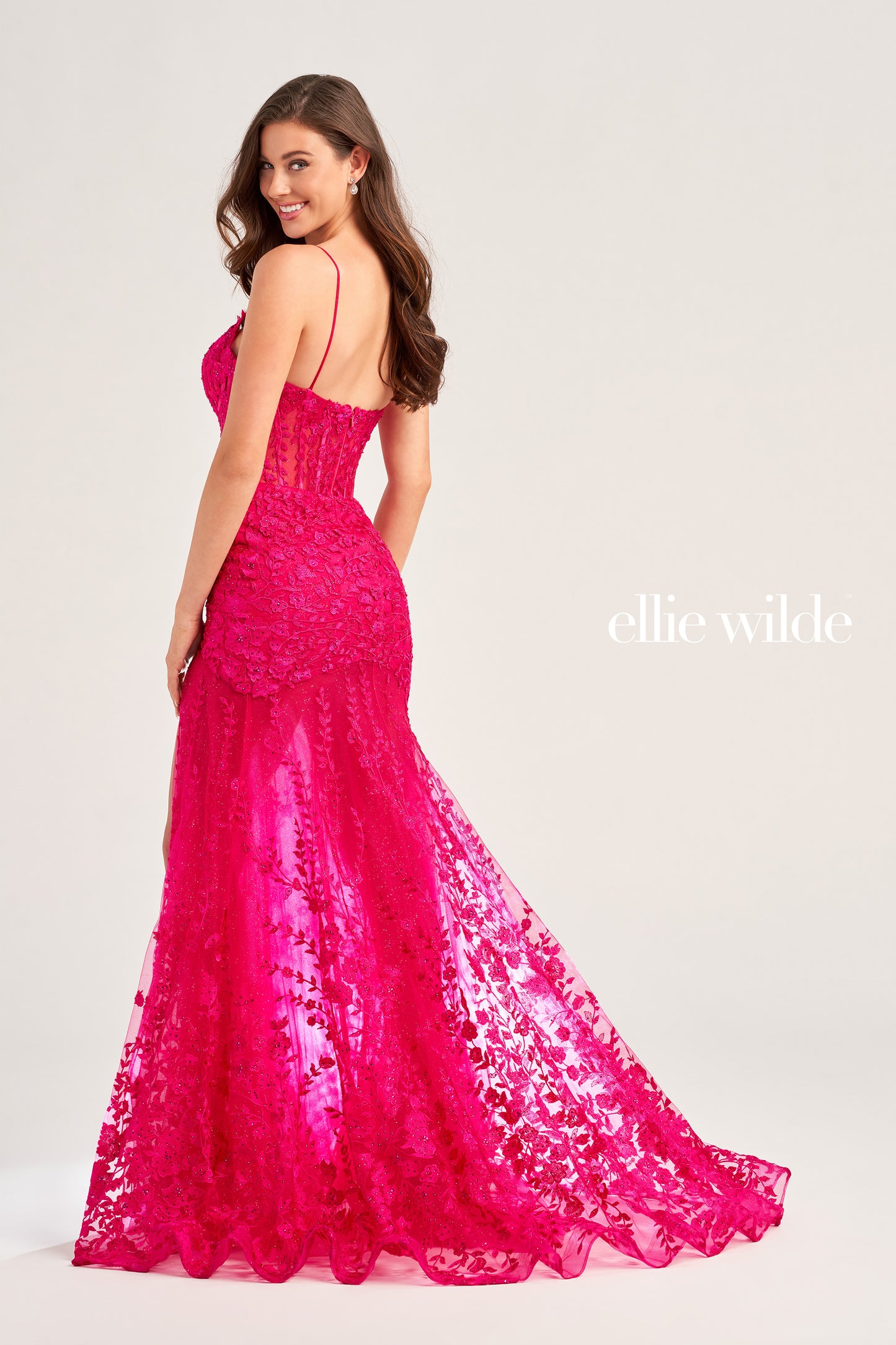 This Ellie Wilde EW35005 Sheer Corset Shimmer Lace Slit Prom Dress Formal Gown adds an elegant touch to formal events. Featuring a sheer corset with shimmer lace and an asymmetrical sheer skirt train, this gorgeous gown will make you stand out. Perfect for the special night.  COLOR: RED, LIGHT YELLOW, LIGHT BLUE, MAGENTA, ROYAL BLUE, EMERALD/NUDE, SAGE SIZE: 00 - 16