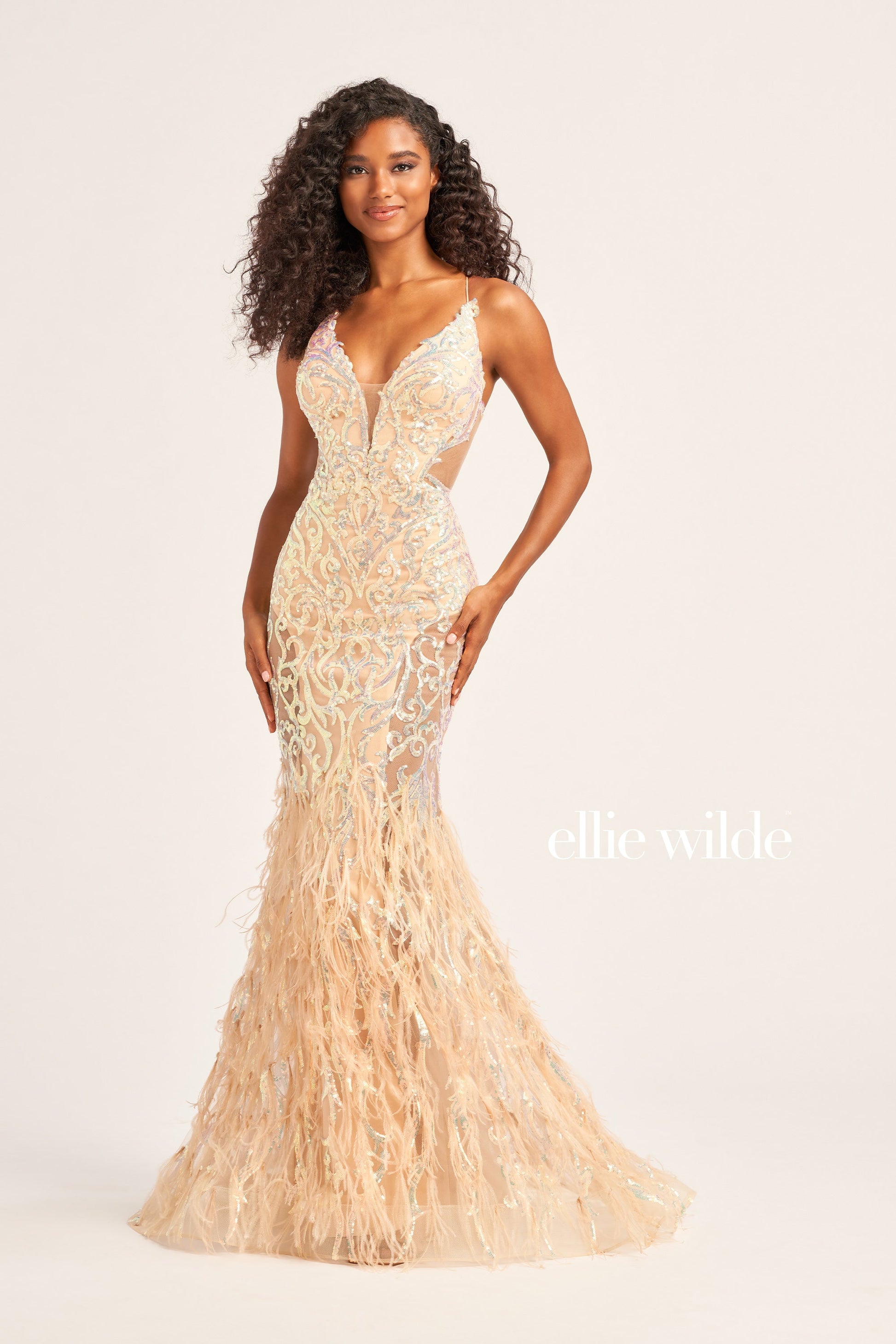 The Ellie Wilde EW35006 Sheer Sequin Prom Dress Gown features a low lace-up back with a side waist mesh inset corset and a glamorous, full-length feather skirt. Look stunning on your special night with this luxurious backless gown.  COLOR: ORANGE, CHAMPAGNE, EMERALD, HOT PINK, IRIS SIZE: 00 - 16