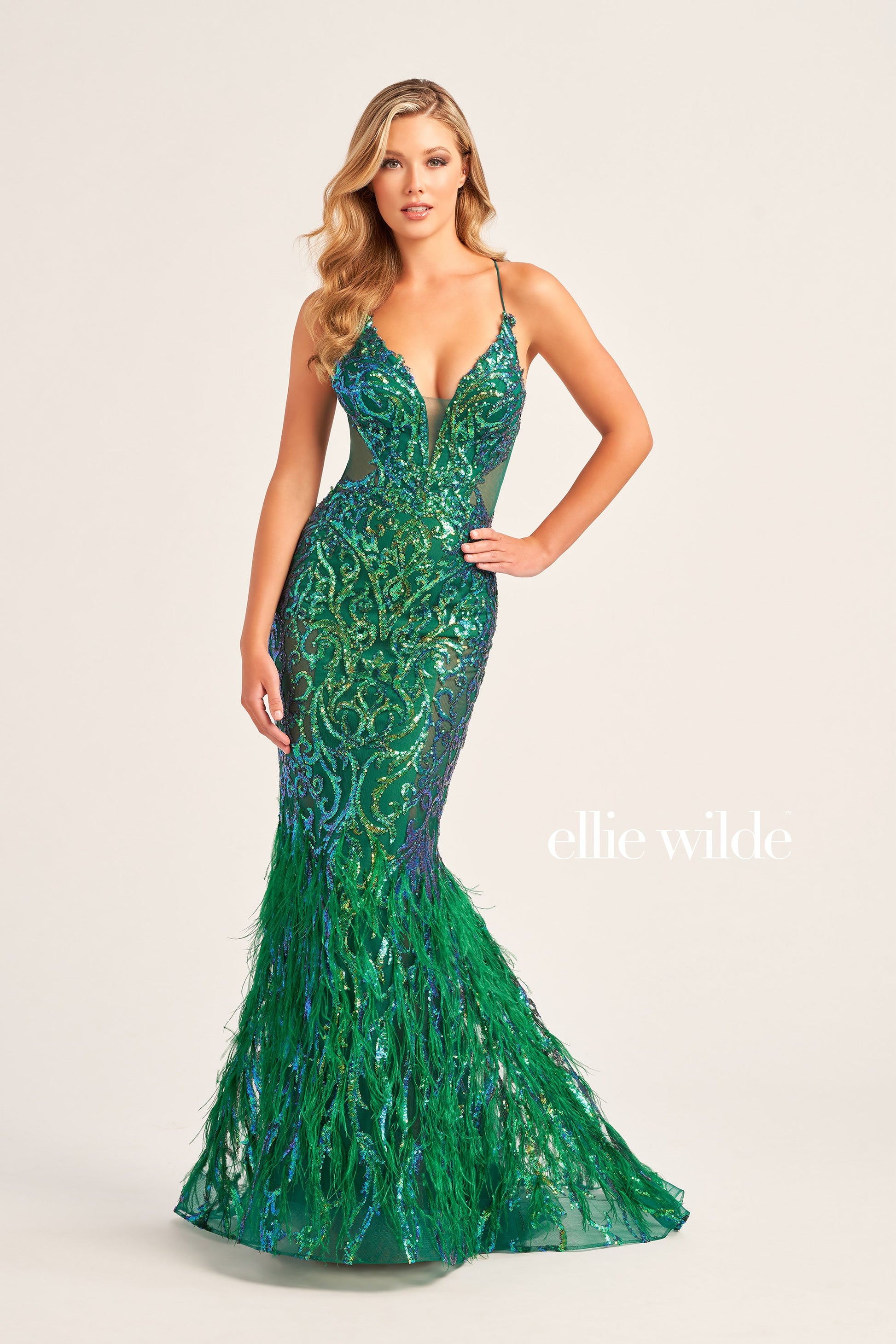 The Ellie Wilde EW35006 Sheer Sequin Prom Dress Gown features a low lace-up back with a side waist mesh inset corset and a glamorous, full-length feather skirt. Look stunning on your special night with this luxurious backless gown.  COLOR: ORANGE, CHAMPAGNE, EMERALD, HOT PINK, IRIS SIZE: 00 - 16