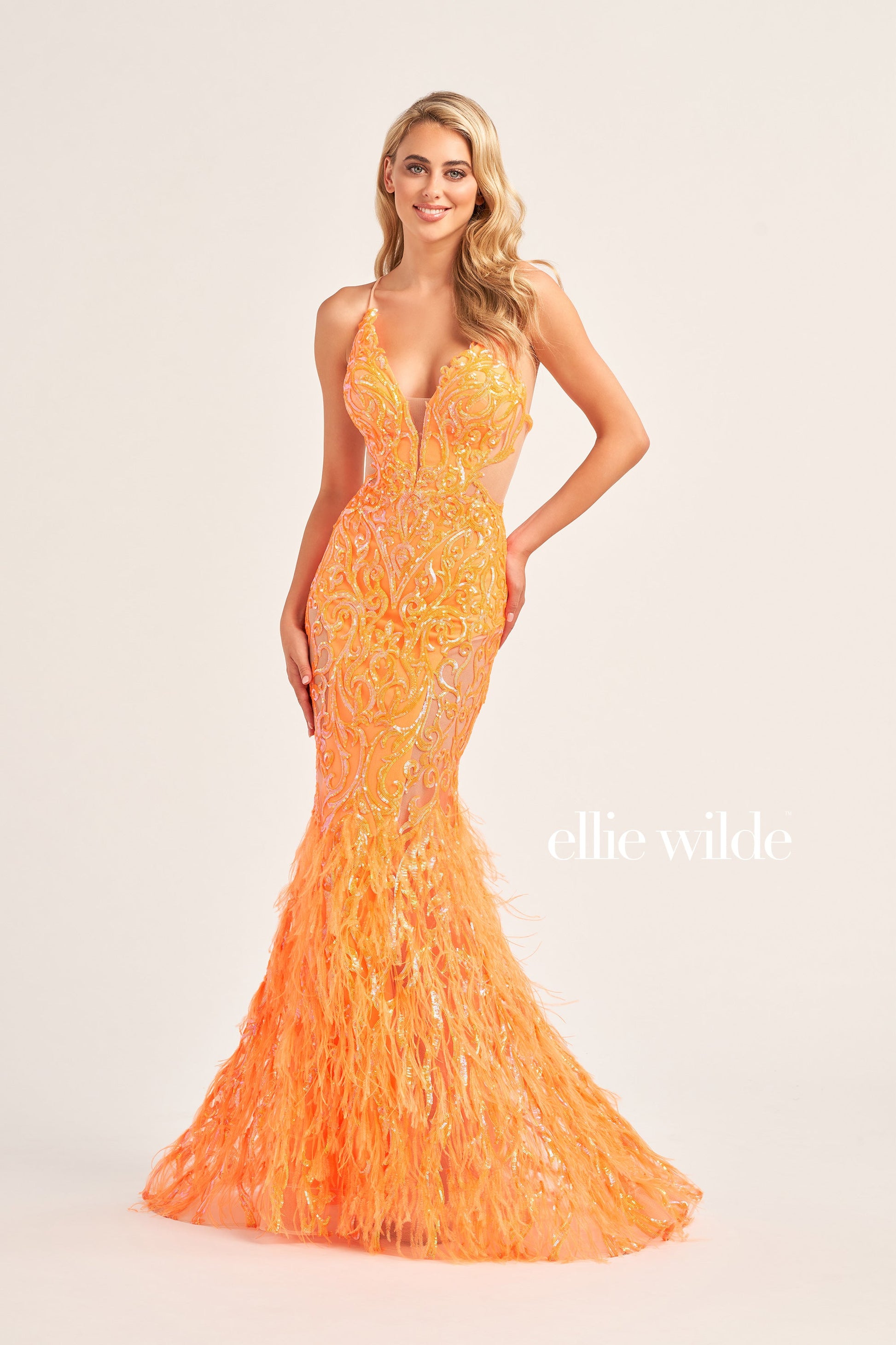 The Ellie Wilde EW35006 Sheer Sequin Prom Dress Gown features a low lace-up back with a side waist mesh inset corset and a glamorous, full-length feather skirt. Look stunning on your special night with this luxurious backless gown.  COLOR: ORANGE, CHAMPAGNE, EMERALD, HOT PINK, IRIS SIZE: 00 - 16