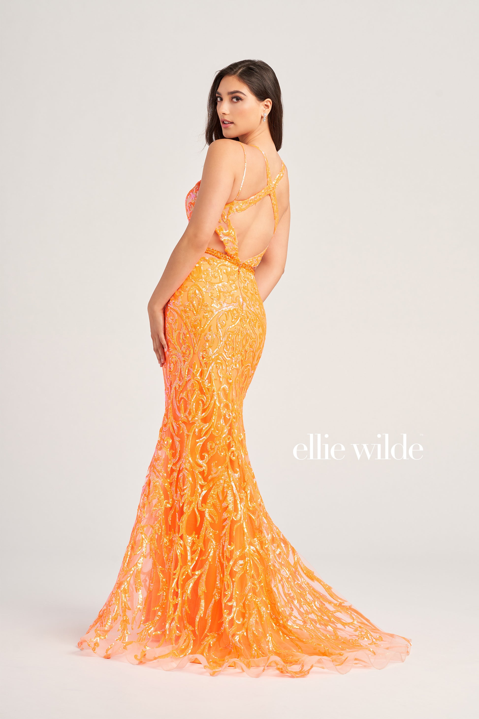 Make a statement in Ellie Wilde's EW35007 Sheer Sequin Cut Out Prom Dress. With its V-Neck Sweetheart Neckline, open back, side waist cut out, and sequin-beaded tulle fabric, this trumpet silhouette gown is an eye-catching formal look. Perfect for any special occasion.  COLOR: ORANGE, EMERALD, IRIS SIZE: 00 - 16