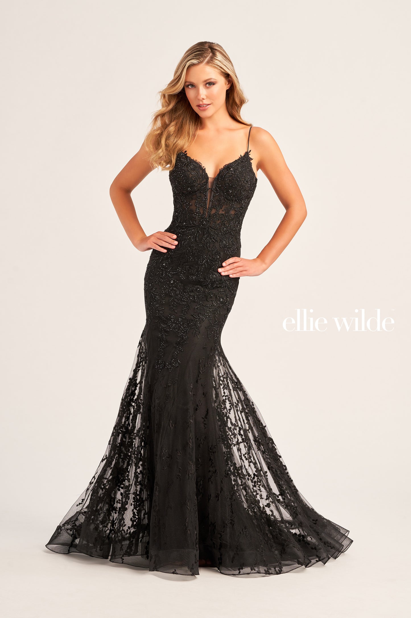 The Ellie Wilde EW35010 dress features a plunging sweetheart neckline, corset bodice, and lace-up back to flatter your figure while adding a touch of sophistication. Crafted from shimmering tulle, glitter tulle, lace, and embellished with stone accents, this long trumpet silhouette is perfect for making a statement on your special day. Plus, this dress is designed with a natural waistline for comfort.  COLOR: BLACK, ORANGE, LIGHT YELLOW, MAGENTA, EMERALD, ROYAL BLUE, SAGE, STRAWBERRY SIZE: 00 - 20