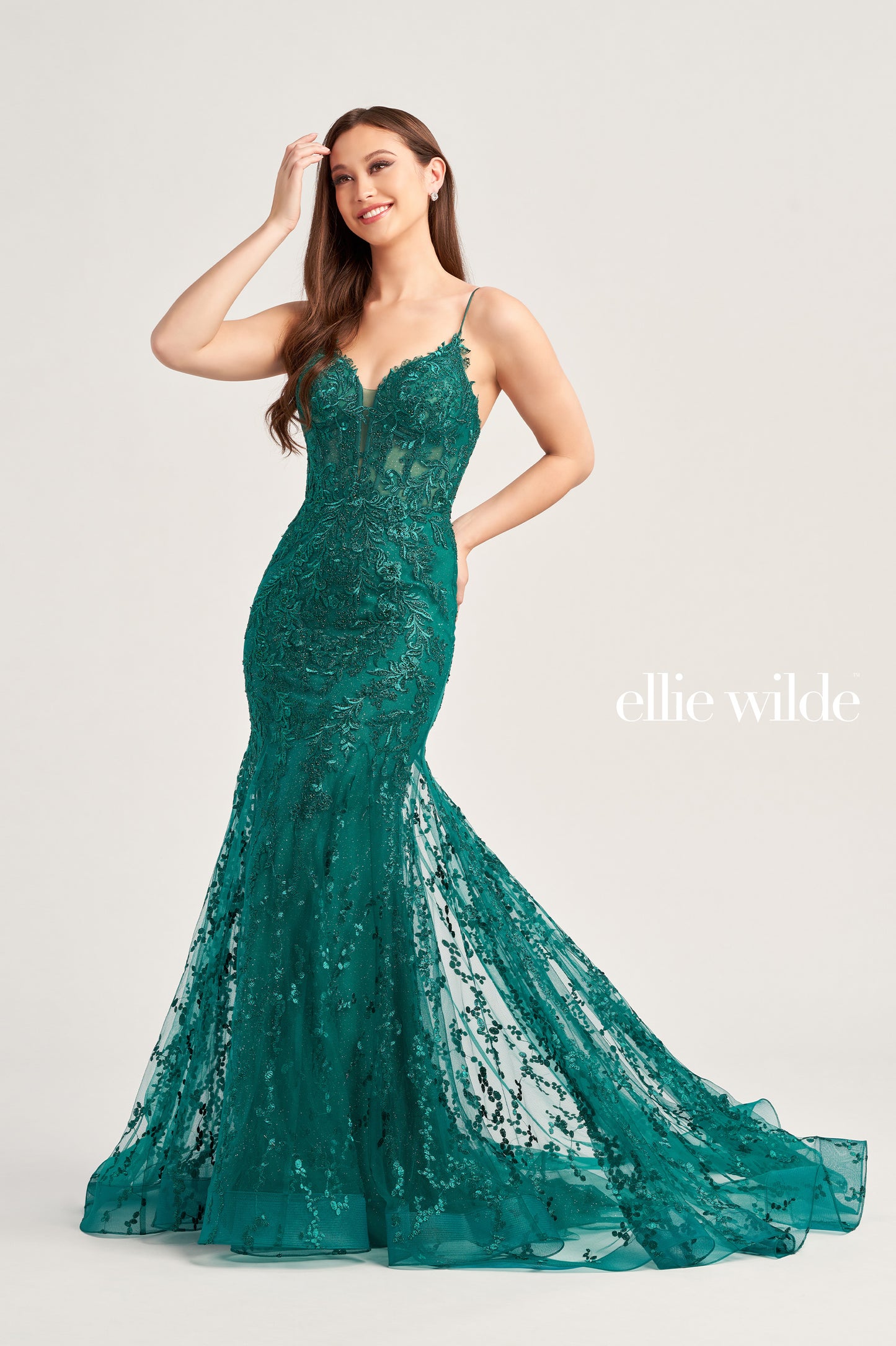 The Ellie Wilde EW35010 dress features a plunging sweetheart neckline, corset bodice, and lace-up back to flatter your figure while adding a touch of sophistication. Crafted from shimmering tulle, glitter tulle, lace, and embellished with stone accents, this long trumpet silhouette is perfect for making a statement on your special day. Plus, this dress is designed with a natural waistline for comfort.  COLOR: BLACK, ORANGE, LIGHT YELLOW, MAGENTA, EMERALD, ROYAL BLUE, SAGE, STRAWBERRY SIZE: 00 - 20