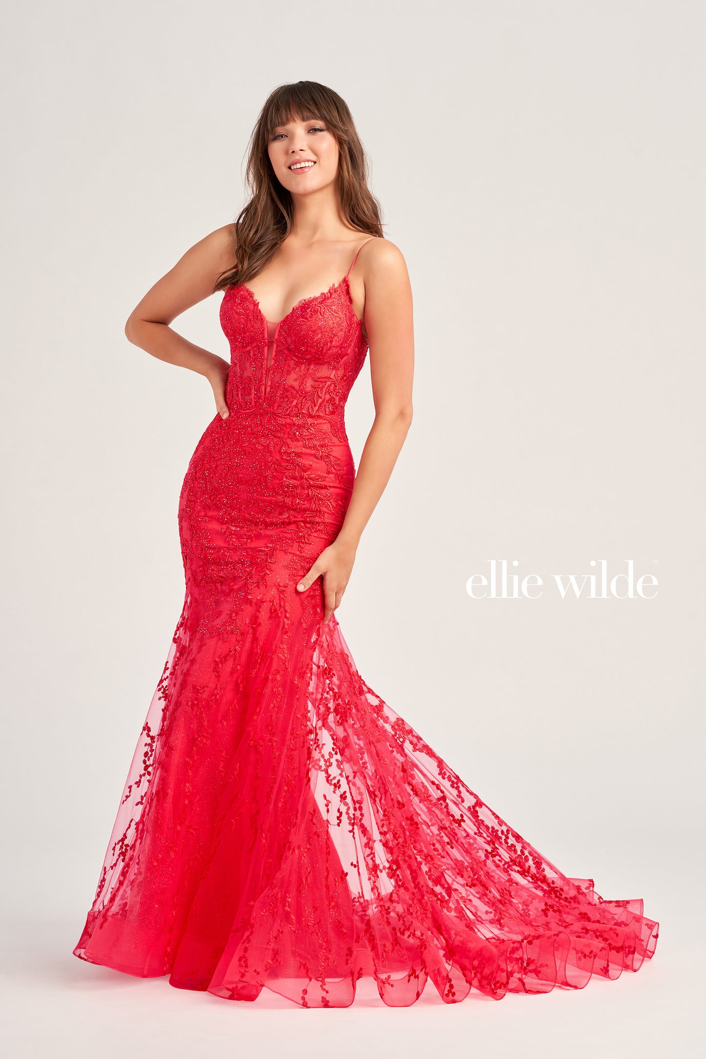 The Ellie Wilde EW35010 dress features a plunging sweetheart neckline, corset bodice, and lace-up back to flatter your figure while adding a touch of sophistication. Crafted from shimmering tulle, glitter tulle, lace, and embellished with stone accents, this long trumpet silhouette is perfect for making a statement on your special day. Plus, this dress is designed with a natural waistline for comfort.  COLOR: BLACK, ORANGE, LIGHT YELLOW, MAGENTA, EMERALD, ROYAL BLUE, SAGE, STRAWBERRY SIZE: 00 - 20