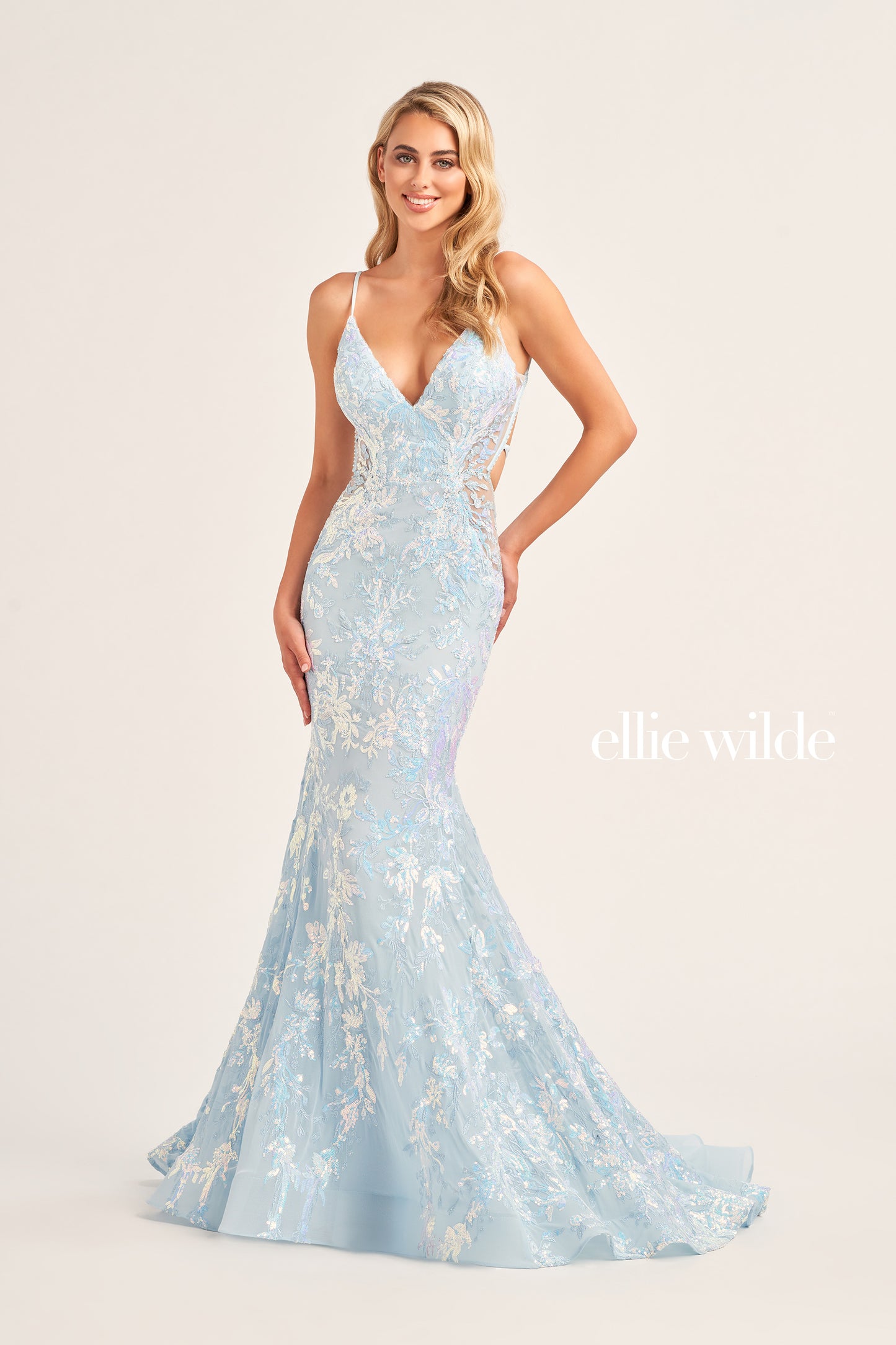 The Ellie Wilde EW35011 Long Mermaid Prom Dress features an eye-catching sequin tulle fabric, a flattering V-neckline, and a unique side waist cut out for a figure-hugging, yet comfortable fit. This gown also includes a lace-up back and a natural waistline for a dazzling and memorable look.  COLOR: BLACK, RED, LIGHT BLUE, EMERALD, LAVENDER, HOT PINK, DUSK, CERULEAN BLUE SIZE: 00 - 16