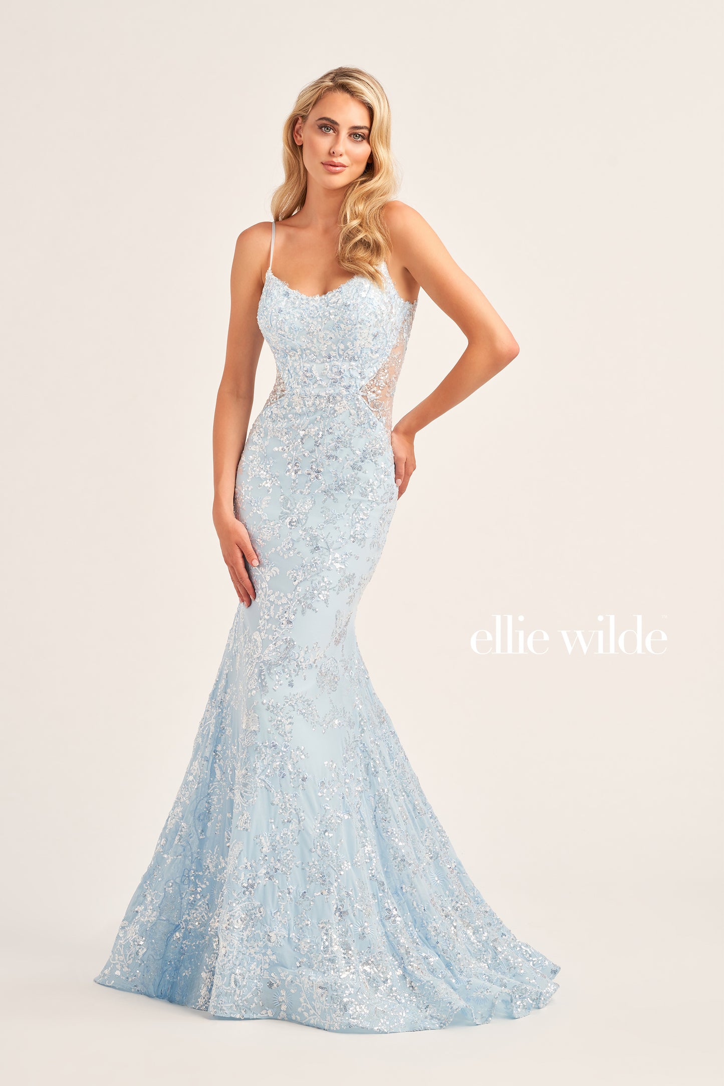 The Ellie Wilde EW35015 is a unique showstopper, featuring a fitted sequin stretch mesh fabric with a long length, scoop neckline, mermaid silhouette, sleeveless design, open back and natural waistline. Perfect for pageants, prom or any special occasion.  COLOR: MIDNIGHT, LIGHT BLUE, LILAC, HOT PINK SIZE: 00 - 16