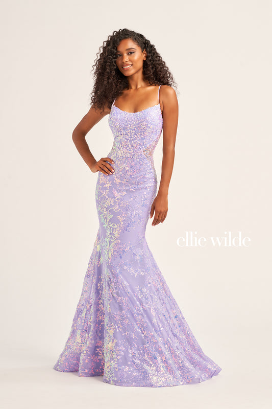 The Ellie Wilde EW35015 is a unique showstopper, featuring a fitted sequin stretch mesh fabric with a long length, scoop neckline, mermaid silhouette, sleeveless design, open back and natural waistline. Perfect for pageants, prom or any special occasion.  COLOR: MIDNIGHT, LIGHT BLUE, LILAC, HOT PINK SIZE: 00 - 16